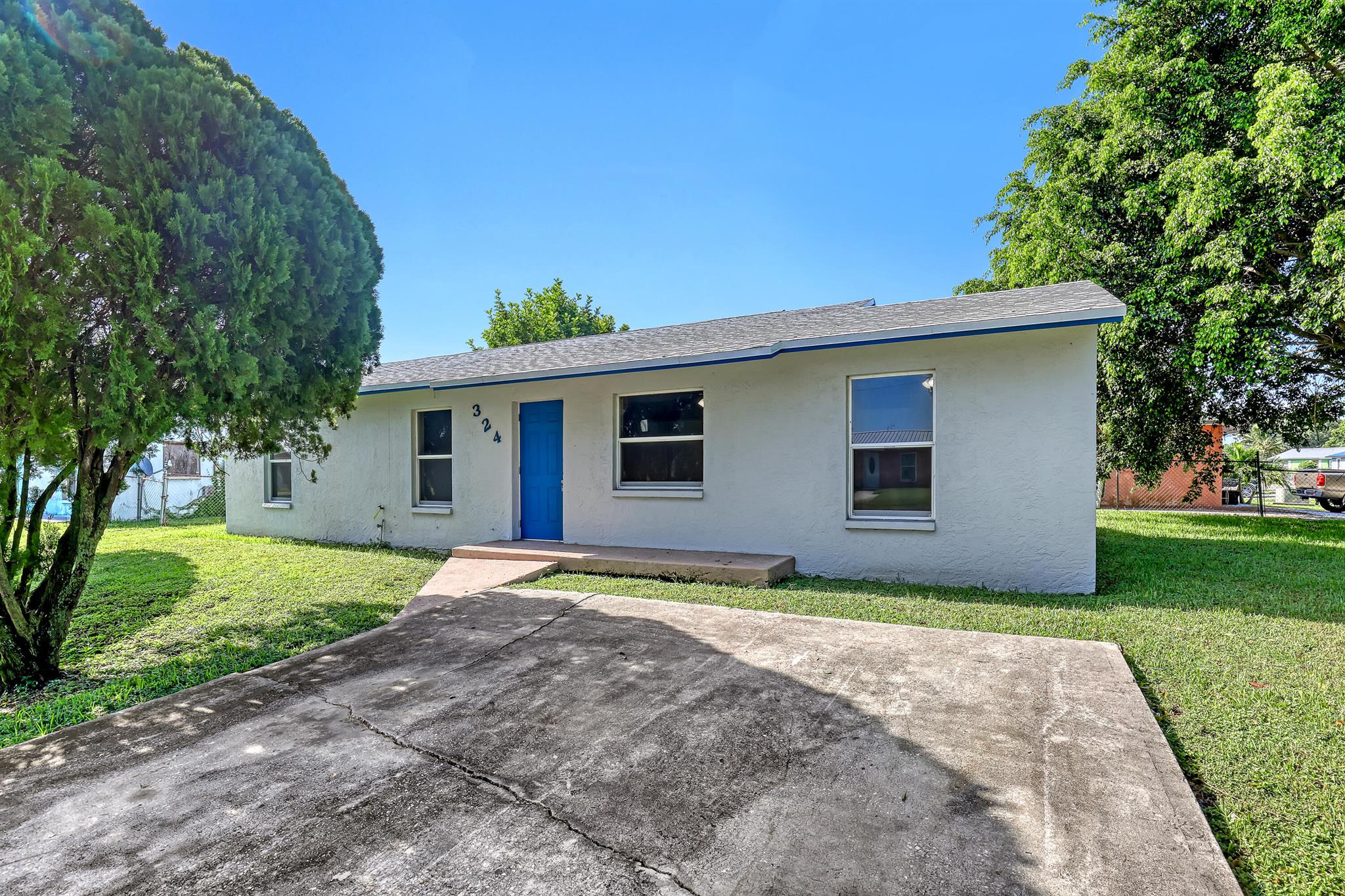 Stunning fully remodeled 4-bedroom, 2-bathroom home on a spacious corner lot in a quiet, well-established neighborhood near Lake Okeechobee. This beautifully updated property features an open layout with high-end finishes throughout, including quartz countertops, modern cabinetry, and quality flooring. Every detail has been thoughtfully designed for comfort and style. Enjoy the peaceful surroundings, plenty of yard space, and the convenience of being just minutes from outdoor recreation and dining. This is the perfect blend of luxury and location.