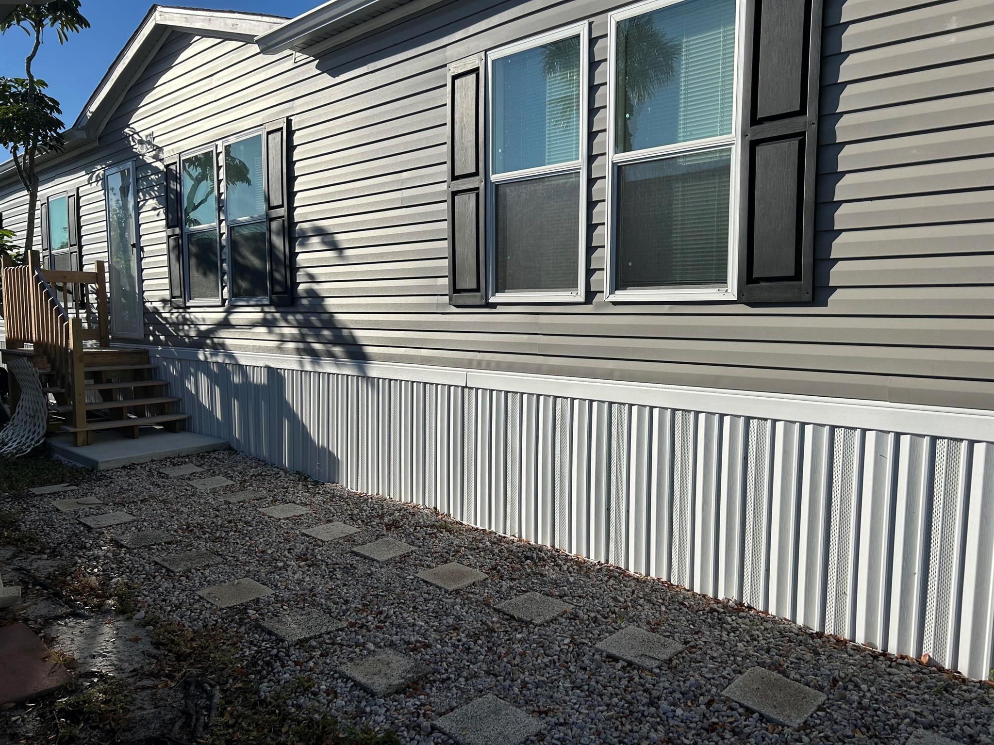 Brand new manufactured home LAND INCLUDED Live Oak Builder Nitro model 1550 sq ft located in Leisure Village co-op low HOA $275 month includes water, sewer, lawn, cable & community pool Living in Paradise just doesn't get any more affordable than this! Leisure Village is an active adult community perfectly located to shopping, Historic Downtown Stuart and all major roadways. Meticulously maintained and Ready to move in.. It is the perfect winter getaway. Enjoy your day socializing at the clubhouse in heated pool or engage with neighbors, friends in a game of bocce ball or shuffleboard. 3 beds 2 baths Central AC In-unit, laundry. Off-street parking. Unfurnished,cable TV, Ceiling fans, dishwasher. microwave, refrigerator, Walk-in closet.
