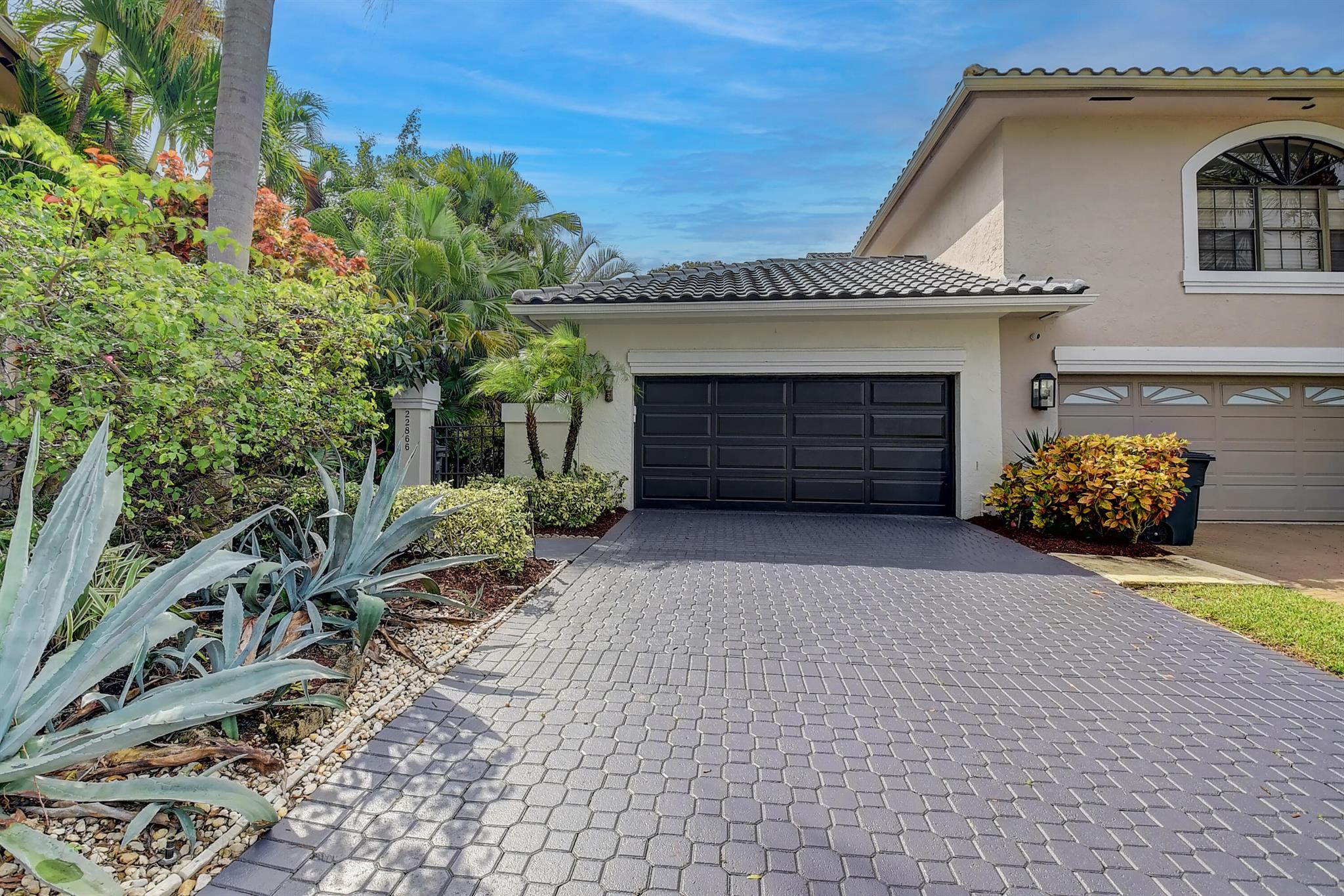 Available for January and February 2026, this absolutely stunning end-unit home is being offered fully turnkey for your seasonal retreat. A tropical courtyard entry welcomes you into a light-filled residence with dramatic windows and glass doors framing beautiful views. The home has been extensively upgraded, a gourmet kitchen with wood cabinetry, granite countertops and backsplash, and stainless steel appliances. The living areas feature striking stonework on the fireplace and bar, custom closets, designer lighting, and plenty of room for entertaining. Upstairs you'll find all-wood flooring, renovated bathrooms, and a tiled deck, while the rear patio offers an ideal spot to relax. A screen-enclosed lanai with a heated private pool completes this perfect seasonal escape.