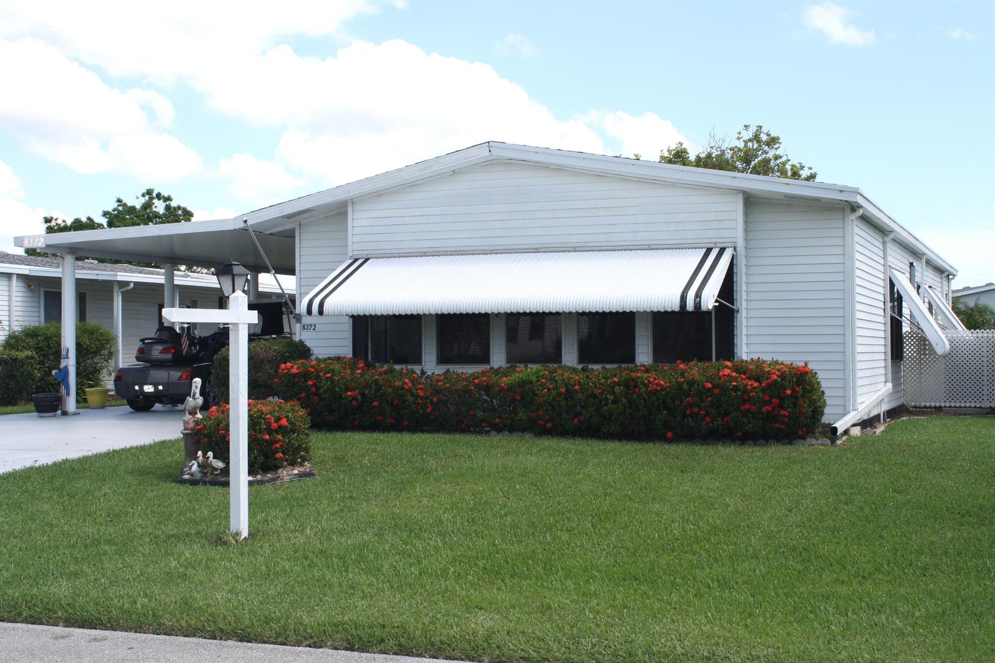 LAND OWNED - Spacious & Open Floor Plan, this 2/2 has large island kitchen, and many updates which includes AC 2023, New AC Duct work under the home, 2024 vapor barrier, new 2025 laminate flooring in living and dining room, newer wood laminate and subfloor in family room, new paint in kitchen, dining and living room. Large enclosed glass porch with new carpet. HOA includes cable, internet, trash and access to all the amenities. Savanna Club activities include an 18-hole golf course, 3 pools, 3 exercise rooms, an on-site restaurant, a theater, pickleball, billiards, tennis, and numerous other activities to enjoy.