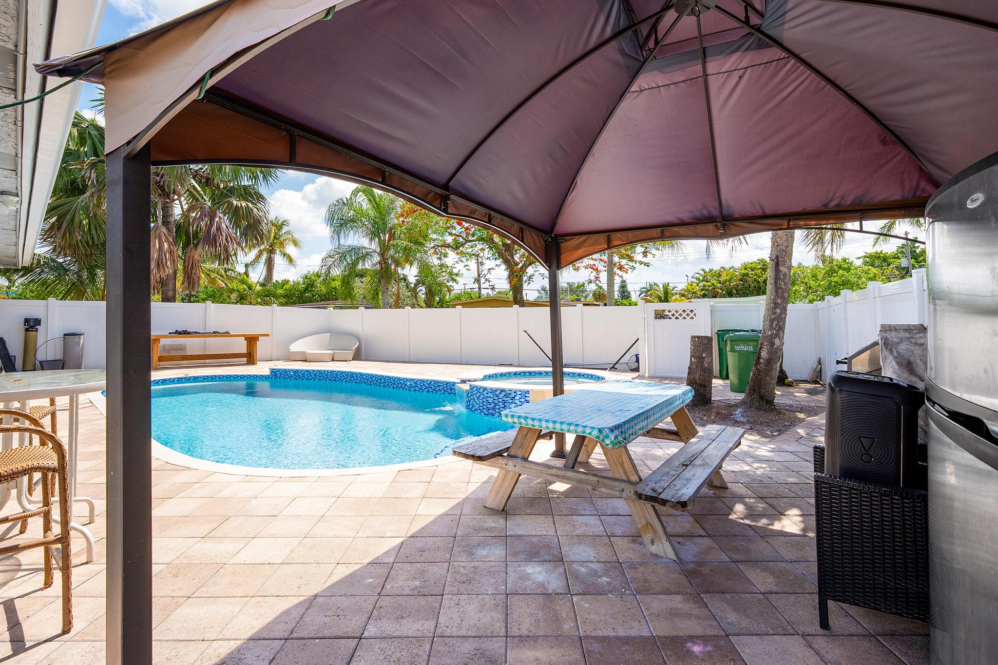 This unique 3-BED, 3-BATH home PLUS a DETACHED 1-BED, 1-BATH GUEST HOUSE sits on a spacious CORNER LOT in a NON-GATED community with NO HOA. The main house features FLAT CEILINGS, CROWN MOLDING, RECESSED LIGHTING, WHITE TILE FLOORS, and a SPACIOUS KITCHEN with PLENTY OF CABINET SPACE. The BONUS ENCLOSED FLEX ROOM includes IMPACT WINDOWS & DOORS, adding extra interior square footage. The DETACHED GUEST HOUSE offers a FULL KITCHEN, BATHROOM, WASHER/DRYER, and PRIVATE ENTRANCE--CURRENTLY RENTED FOR $1,350/MONTH--ideal for income, in-laws, or a home office. Backyard is FULLY PAVED and features a HEATED POOL, JACUZZI, MINI OUTDOOR KITCHEN, STORAGE SHED, and FULLY FENCED YARD--perfect for entertaining. CIRCULAR DRIVEWAY provides AMPLE PARKING. Tons of potential for investors or end-users!