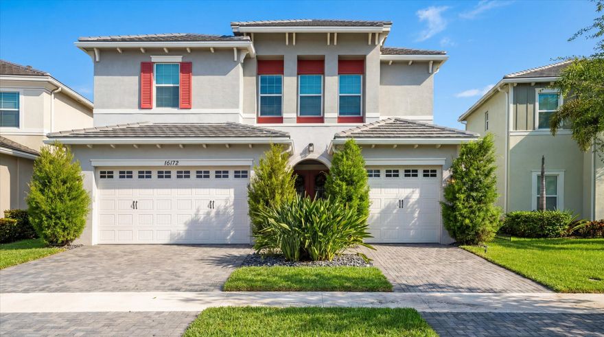 True showstopper. This exceptional five-bedroom lakefront residence stands apart with custom finishes and design details not typically found in Westlake's newer construction homes. A grand double etched-glass entry with bespoke wood ceiling, opens to a striking wood staircase with custom inlay and rich engineered wood flooring that extends through the office, staircase, and entire second level, all complemented by crown molding throughout. A refined front living space with dramatic coffered beam ceilings, private office with double glass doors, spacious family room, and a reimagined dining area create a layout that is both elegant and functional. The fully upgraded kitchen impresses with ceiling-height cabinetry with glass accents, quartz countertops with a bold mitered edge, a decorative wood-paneled island, double ovens, cooktop, upgraded appliances, wine cooler, and reverse osmosis system. A beautifully finished butler's pantry with glass-front cabinetry and quartz counters, along with a custom-built pantry, adds exceptional storage and style. Upstairs, a generous loft leads to five bedrooms, including a stunning primary suite with lake views, custom drapery, and a dramatic navy designer ceiling accented with detailed double crown molding. The spa-like primary bath features a frameless glass shower, dual square sinks, upgraded lighting, wood-look tile flooring, and a smart toilet with built in bidet, auto flush, heated seat and air-drying function. Enjoy exceptional outdoor living with a covered lanai featuring a custom wood ceiling, plus an extended screened-in patio enclosure—perfect for relaxing or entertaining while taking in the serene lake views—enhanced by electric retractable awnings. Additional highlights include a three-car garage with epoxy flooring and overhead storage, impact windows and doors, keyless entry, and custom trim work throughout. Residents enjoy resort-style amenities including Adventure Park with lagoon pool, waterslide, splash pad, fitness trail, dog park, playground, and more.