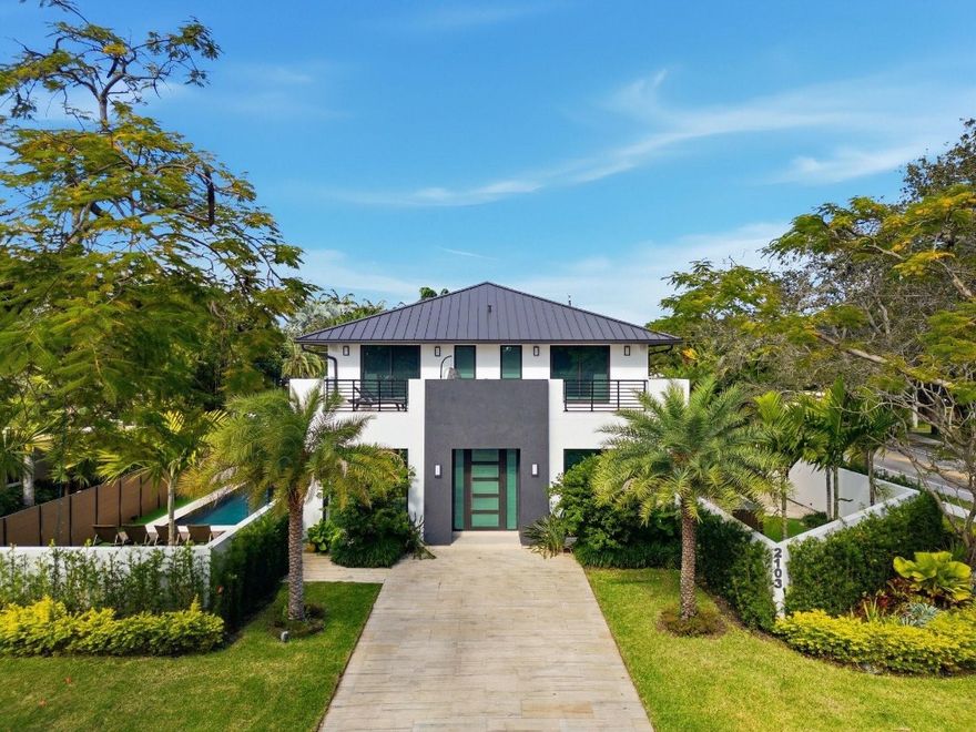 Luxurious New Construction in sought-after Coral Ridge. No detail was spared in this modern residence designed for refined indoor-outdoor living. Featuring high-ceilings, split-floor plan, 4 en-suite bedrooms, 4 Baths, 1 half bath, office, and den. Limestone tile, sound insulated German custom interior doors, Nolte German kitchen and bath cabinetry, and premium Miele appliances. Large second-floor terrace with spiral staircase leading the heated saltwater pool, expansive covered patio with summer kitchen, and outdoor shower. Fully integrated smart home with Lutron HomeWorks, Control4, Sonos speakers, and shades all app-controlled. Impact windows/ doors, aluminum roof, two-car garage, EV charger and parking for up to 8 vehicles. Minutes to the beach, dining, shopping and Bayview Elementary,