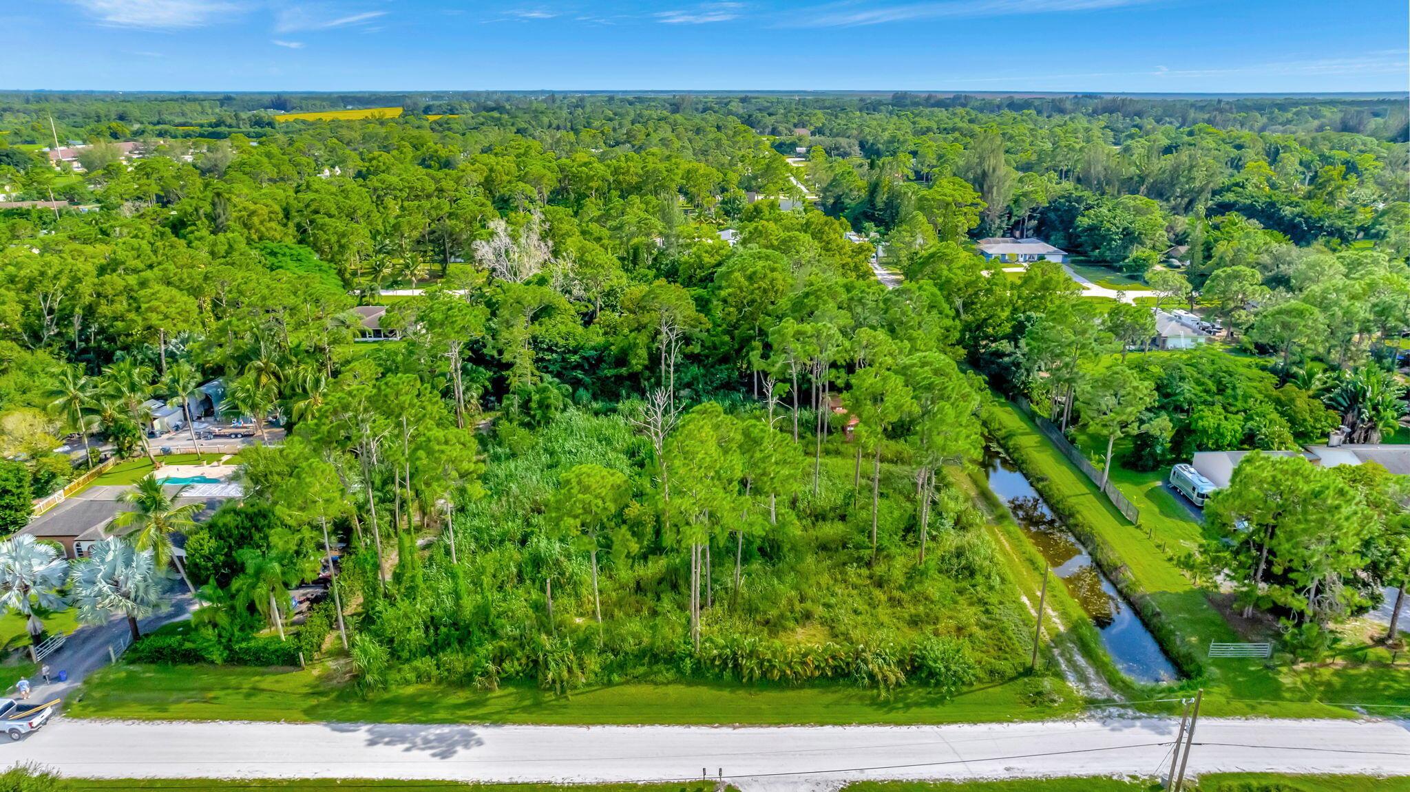 Exceptional opportunity to own a piece of paradise in the heart of Loxahatchee. This expansive 1.31 acre lot is the perfect option for you to build your dream home, have a guest house, create an equestrian estate, or establish a serene retreat away from the hustle and bustle of city life. Located right next to Westlake, just 28 minutes from the Palm Beach International airport, and 11 minutes from the beautiful Wellington. Just a short drive from shopping centers, schools, parks, and major highways, ensuring you're never far from what you need while still enjoying the seclusion this property offers.
