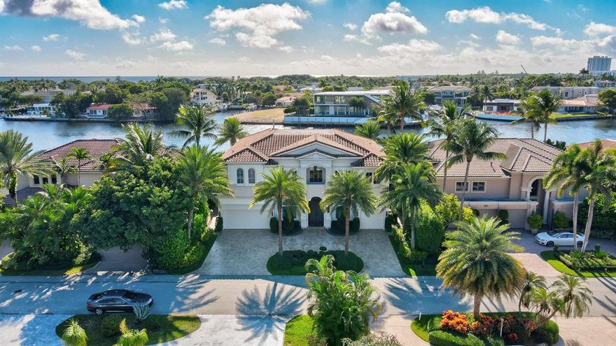 This 'Best of the Best' offering has a Direct Intracoastal 'Non-Wake' location with stunning east and southeast waterway views. Boat dockage exceeds 70 feet.   Exquisitely updated and immaculately maintained, this residence features a first floor bedroom suite, with the primary bedroom (which features a full sitting room) and two additional bedroom suites, and a dedicated exercise room, on the second level. The foyer opens to spacious dining room and a two story great room with fireplace and bar. The newer kitchen opens to the family area and dinette, all overlooking the pool, patio and waterway. 
The marble paver pool patio, a covered patio area, barbecue, and pool which is being refinished complete the tropical paradise backyard area.  See MORE for additional details... Generac Generator 48kw
4 Air Conditioners - Trane
Impact windows 
Circular driveway
3 car garage -split 
Exterior of home recently painted
Fenced in backyard
Crown molding throughout whole house
Turf grass
Lighting system

Foyer:
2 floor foyer
Dennis and Leen Chandelier 
Gold dome ceilings through hallways, custom painted by local artist

Formal living room:
2 floor high ceilings
Double pane windows floor to ceiling
Overlooking the intracoastal
Decorative fireplace - floor to ceiling
Francois Custom stone mantel w/ gas logs
Plaster decorative ceilings

Bar area:
Counter seats 3
Wet bar copper sink
Brass fixtures
Scotsman Ice maker
Bar fridge
limestone counter tops 

Kitchen:
Recently renovated
Marble counter tops
Custom cabinetry
Francois custom made hood
Wolf 6 stove range with dual oven
2 sub-zero Built-in refrigerator
Built in beverage drawers
Built in dual freezer drawers
Hidden coffee bar 
Dishwasher
Shaws of England ceramic sink
Waterworks backsplash & sink features
Lots of cabinet storage
Built in glassware and china cabinets
Breakfast area and bar counter area


Family room:
Overlook the intracoastal with bright windows
Custom shades and drapery
Coffered ceilings
Built in lighting

Walk in pantry
Wine cellar w/ chandelier - climate controlled


Dining room:
Paneled wall with gold trim
Built min mirrored walls
Silk Drapery 
Double light fixtures decorative
Wall sconces
Comfortably seats 10 


Office/Den:
Built in custom shelves
Fabric lined ceiling with built in lights 
Crown molding
Custom drapery
Dennis and Leen chandelier with rock crystals

Guest suite:
Hardwood floors
Double glass doors to pool area
Bathroom suite
Marble flooring
Marble countertop
Walk in shower 
Frameless glass door

Powder room:
Quartz sink counter top
Toto toilet
Custom painted mural walls

Elevator
With accordion door shutters

Wooden stairs with iron railings
Carpeted stairs



Upstairs utility room
Large sink 
GE washer & dryer 
Front loading

Bedroom suite 
Hardwood floors
Walk in closet
chandelier
Bathroom
Marble flooring
Walk in shower frameless door
Marble sink countertop
Wall papered
Built in vanity mirror

Bedroom Suite #4
Direct intracoastal
Hardwood floors
Walk in closet
Crystal and brass chandelier

Open walkway bridge
Overlooks living room and foyer

Exercise room with small balcony
Gym flooring
Ceiling fan
Mirrored walls

Denon av system
Server room

Primary room suite
Long hallway 
Hardwood floors
Windows overlook intracoastal
Walk out balcony facing waterways
Decorative fireplace 
Sitting room 
Decorative chandelier

Walk in closet with Mahony custom closets
Mirrored doors
Built in dresser
2nd closet with matching Mahony custom built closet

Primary Bathroom
Dual vanity with dual sinks
Sinks are decorated in silver and gold details
Custom cabinetry
Full wall mirrors
Gold brass chandelier
Marble flooring
2 water closets 
One with bidet 
Walk in shower with seat
Jacuzzi tub

Summer Kitchen
Hoshizaki Ice maker
Solaire grill and griddle outdoor stove
Summer kitchen
Boat dock 60 Ft 
Canal width 350 Ft