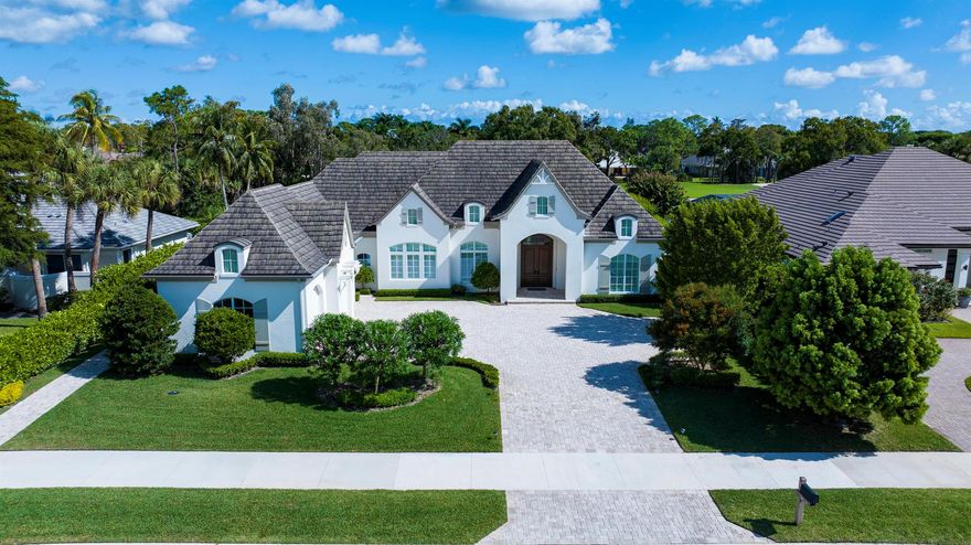 Drawing inspiration from refined European architecture, this exceptional residence is a testament to bespoke craftsmanship and meticulous design. Stately wooden doors open to a grand entrance revealing high-volume ceilings, exquisite Italian porcelain tile, and a spacious open floor plan that artistically blends the charm of the French Countryside with a sleek, clean-lined design.Beyond the grand foyer lies a sitting room featuring a Parisian bistro-style bar with marble countertops and an adjoining living room that offers views of the verdant 16th Fairway Golf Course to the east and breathtaking sunrises to the west.