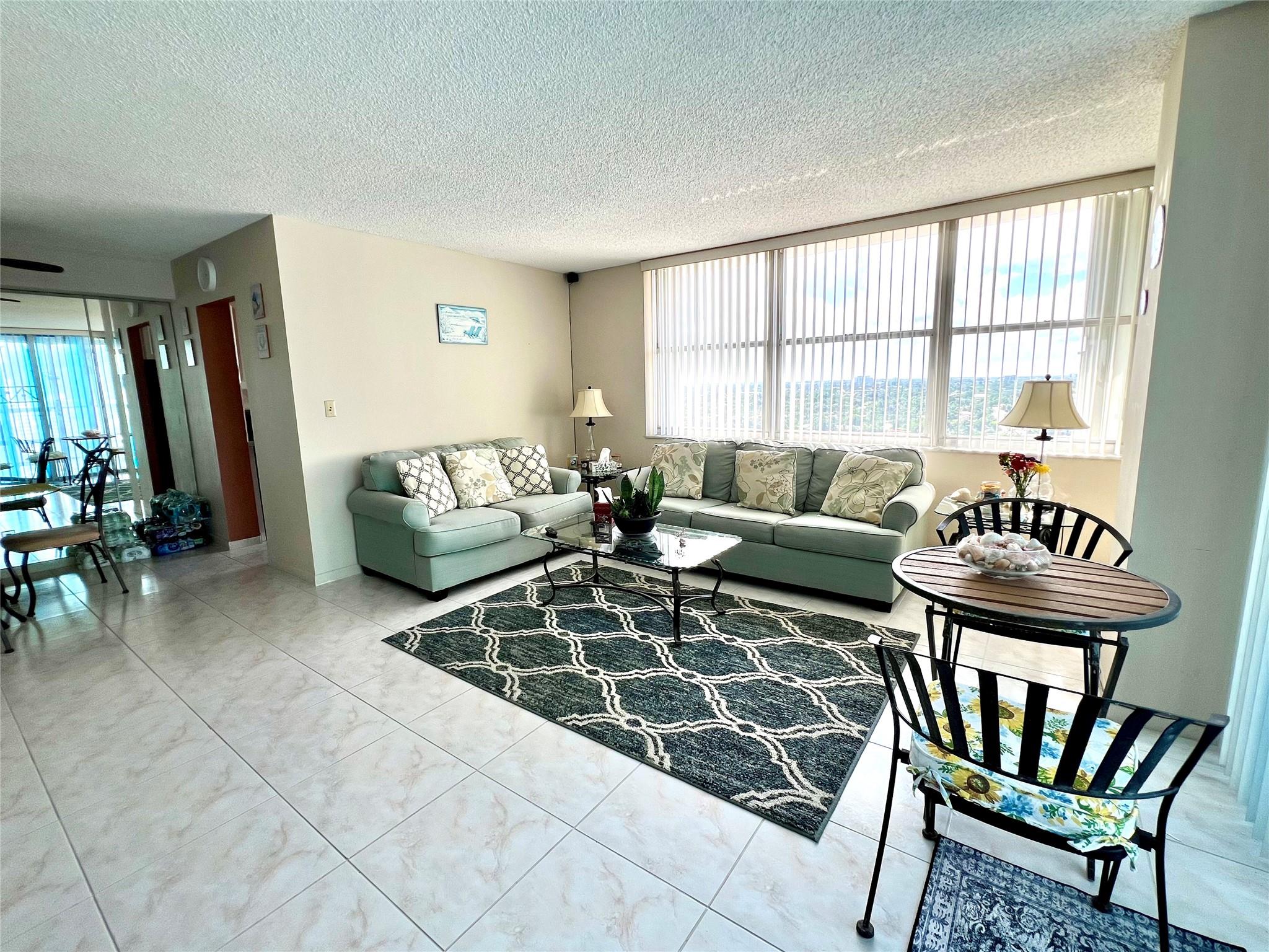 Lovely NW corner 2 bedroom 2 bath condo available for seasonal rental. Wonderful views of the ocean and Intracoastal, beautiful sunsets. Tiled throughout, updated, queen bed in primary bedroom twin and full beds in guest bedroom and pull out sofa in living room. Cable and internet included. Enjoy fabulous amenities in the beachside recreation center with 2 pools, 2 gyms, bbq grills and picnic tables on the beach and so much more. Loads of local activities throughout the season. Located in the heart of revitalized Pompano Beach. Walk to shopping, dining, tiki bar, fishing pier and all that Pompano Beach has to offer. Three month minimum. Building is currently undergoing concrete restoration, balcony may be closed off during lease term.