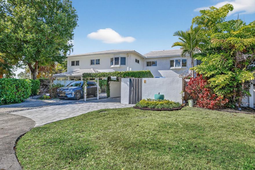 FRESH & NEW 2BR/1.5BA townhouse in Kensington Isle, desirable Wilton Manors. Updates include laminate herringbone flooring, BRAND-NEW HIGH-END KITCHEN with two tone shaker cabinetry and OVERSIZED WATERFALL ISLAND that flows into a wide-open living area. A FULL WALL OF FLOOR-TO-CEILING IMPACT GLASS DOORS & WINDOWS spans the living & kitchen, opening to the sunlit courtyard offering PRIVATE OUTDOOR LIVING & DINING SPACE. SPA-INSPIRED PRIMARY BATH with double vanities & walk-in shower, plus updated guest half bath. Carport with additional exterior storage. Additional upgrades include NEW ELECTRICAL PANEL, TANKLESS WATER HEATER, all-in-one washer/dryer, 2020 roof, 2025 A/C AND VENTS. PET-FRIENDLY community with clubhouse, pool, and guest parking. Steps to bustling Wilton Drive cafés and bars.