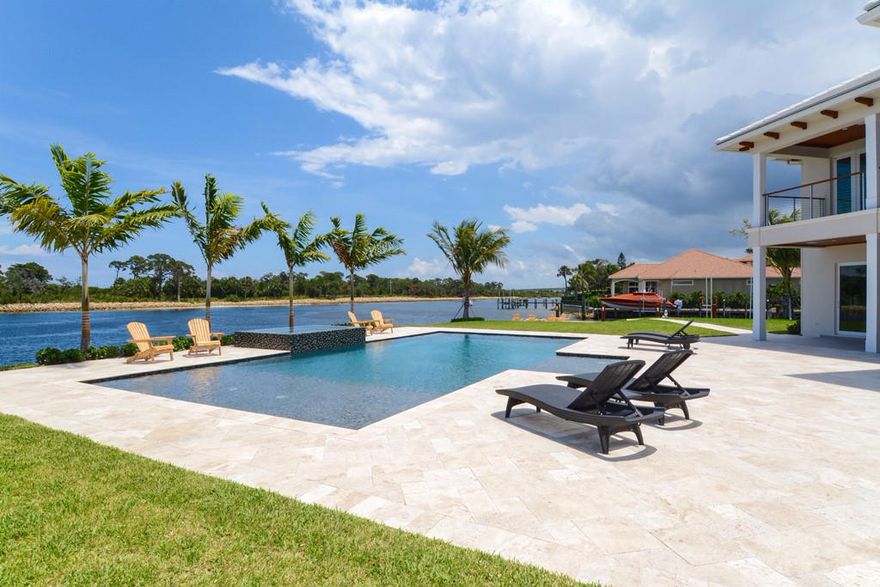 A boater’s delight situated on a large point lot in exclusive Cypress Island with over 200 feet of unobstructed  frontage on the blue intracoastal waterway.  This newly constructed 5 bedroom, 5 bath plus powder bath residence offers the finest in luxury living, a private oasis with views of the natural preserve.  Enter the custom mahagony double doors to expansive living space and amazing water views from most every room.  This home provides 6,928 square feet of living space and 9,002 square feet total.  Spacious outdoor covered patios, gas fire pit, 30,000 lb boat lift and dock with electric and water and tropical landscaping are the ultimate for outdoor living. Custom details throughout include a gourmet kitchen with solid wood kitchen cabinetry, quartz countertops, top of the line appliances, two islands, wine cooler,  ice maker and large pantry.  Relax by the fire in the well appointed library/den with detailed ceilings.  The master bedroom's ceiling to floor windows and covered balcony fill the bedroom with natural light and direct intracoastal views, while the master his and her bathrooms feature dual closets, premium quality vanities, a roman jacuzzi spa tub and large separate showers. Other unique features include 4 secondary bedrooms (one which is wired for a theatre room) complete with ensuite baths, an elevator, 3 car garage with finished floors and the ability for a car lift, 5 zones of A/C, full house generator, impact glass windows throughout, low voltage LED lighting, sound system with cameras, pentair pool system.  Cypress Island amenities include 24 hour manned security entrance, clubhouse with pool and marina.  Located near fine dining, shopping and close to the beach this is Florida living at its finest.  
New 75FT dock equipped with LED lights, a service pedestal with water supply, outlets for 115V, outlet for 50AMP, phone and cable. 30,000 LBS boat lift with a remote control operator
The water depth are 9FT in low tide.