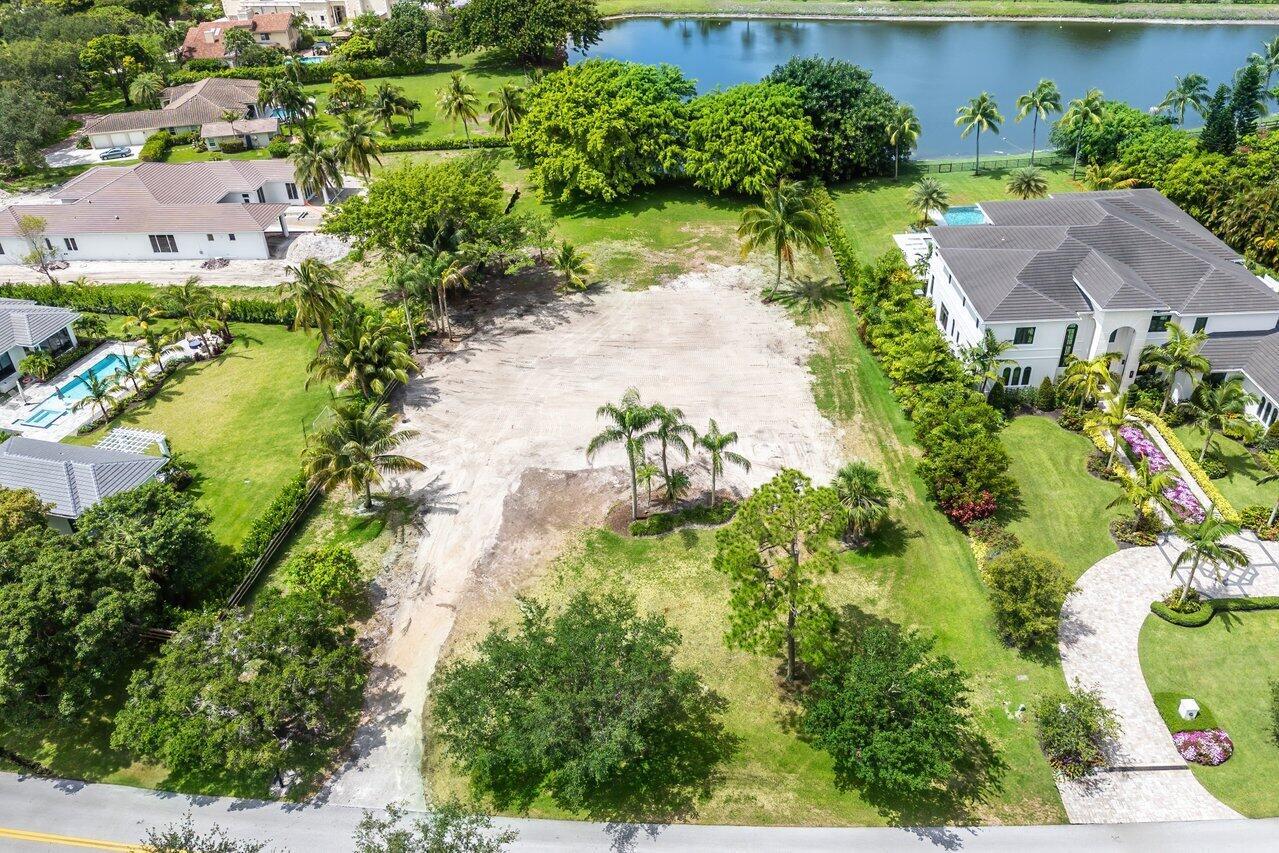 Build your dream home on this spectacular property with a gorgeous water view on over an acre surrounded by mature trees and landscaping. Situated in the exclusive gated community of Steeplechase with 300 custom homes and low HOA fees, this property is nestled in between one home that recently sold for over $7,000,000 and another over $5,000,000. Steeplechase Drive is lined with beautiful oak trees and sidewalks, all homes in the community are on an acre or more with room for tennis / pickleball courts, sport courts, putting greens & more! The community is centrally located w/in Palm Beach Gardens and includes a front and back gate as well as 24 hour roaming security. Less than 15 minutes to the Gardens Mall & area restaurants, 20 minutes from the PBI airport or Jupiter, 15 minutes from