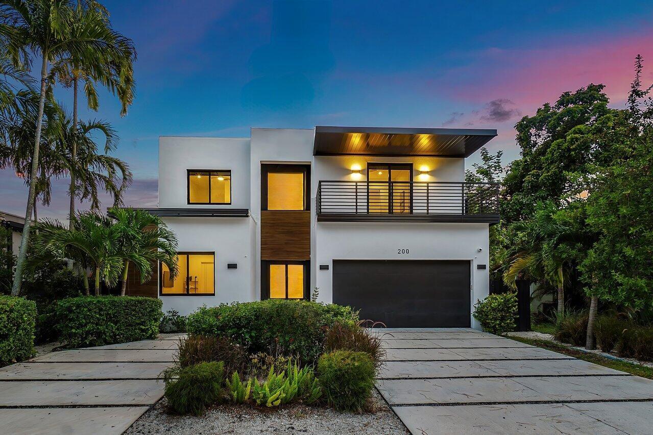Discover this newer modern masterpiece, offered designer furnished and turnkey. This 2-story home boasts 5 spacious bedrooms, 3.5 luxurious bathrooms, and spans over 3,375 sq ft of living space. From its open floor plan, majestic 11' high ceilings, sleek modern kitchen and bathrooms, to it's highest quality of craftsmanship with solid exterior and hurricane impact-resistant windows, every detail reflects contemporary elegance.The property features an Italian kitchen design with quartz waterfall countertops and KitchenAid appliances. The exquisite master suite offers a spa-inspired bathroom, a huge custom walk-in closet, and private balcony. Perfect for entertaining, the home also presents a covered patio, a heated saltwater pool, sun deck, and turf lawn.