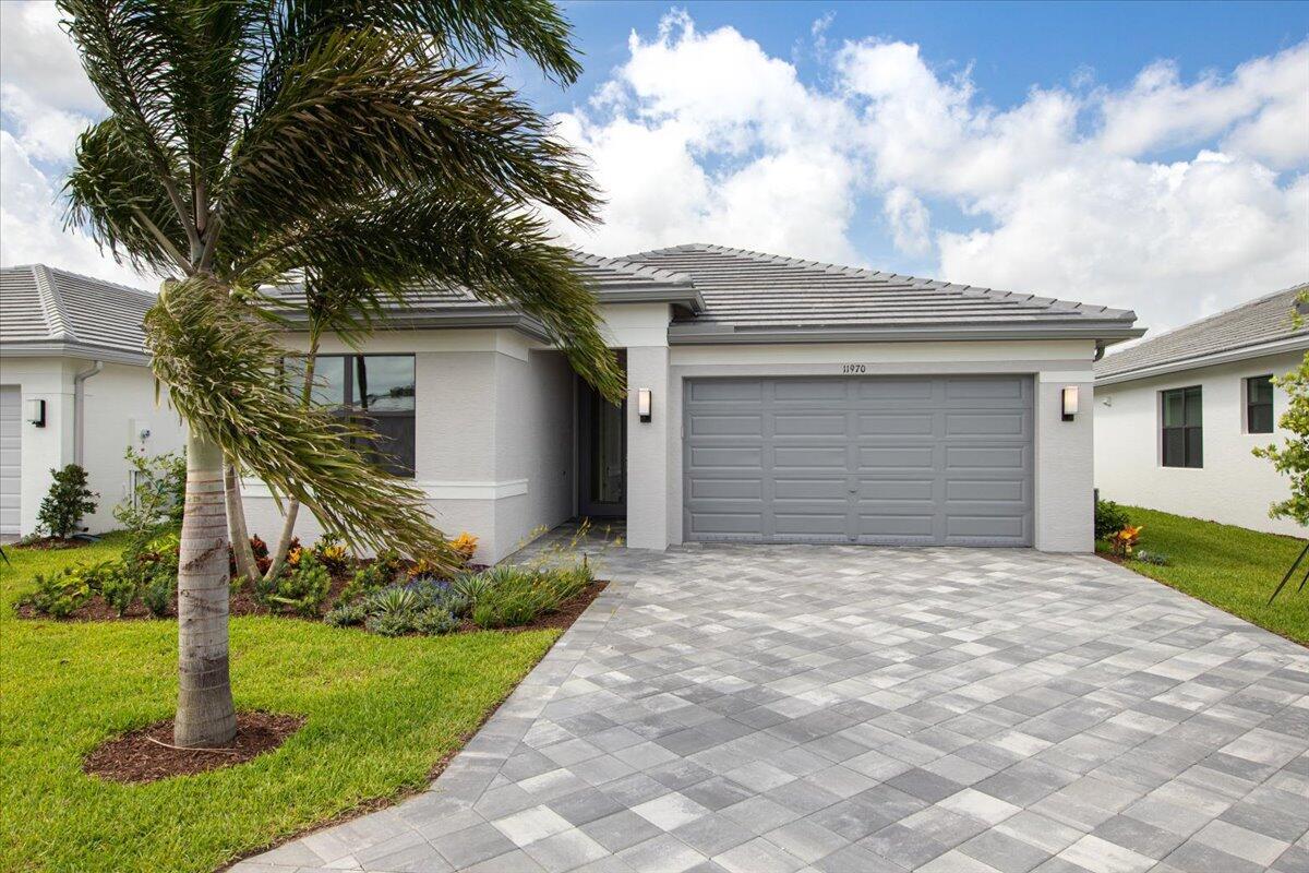 Why wait? This newly constructed home is move-in ready at Valencia Walk. Be the first to live in this popular Sandpiper modelon a premium waterfront lot w/many upgrades: Extended Lanai patio pavers, extended driveway, Epoxy garage floors, upgraded interior Porcelain tile flooring, glass entry door, tankless water heater, stall showers, stainless steel kit appliances, Quartz countertops throughout W/D, gutters, raised toilets, & outdoor patio TV/Internet outlets and, freshly painted Agreeable Gray by Sherwin Williams.