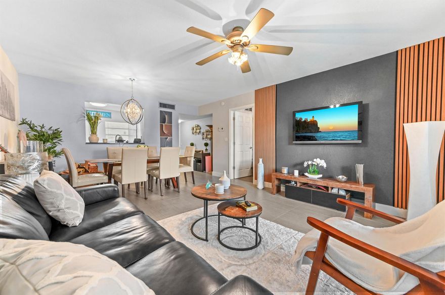 Pristine, fully remodeled 1/1.5 corner unit (793 sf) on the 1st floor, featuring unique, private open patio overlooking canal water views at the Topaz South. Just off of 441 & Commercial Blvd, located within minutes of shopping, dining, parks & major roads. New tile floors, light fixtures & drapes, modern vanities in both baths. Kitchen boasts quartz countertops, mosaic backsplash, updated cabinets & quality appliances. Living room opens to FL room/den, leading to private open patio. Bedroom has 2 closets (1 walk-in) & ensuite bath. Cable, water, garbage included in LOW monthly fee of $414. Unit comes with 1 parking space & guest spaces. Bldg has new roof! Amenities: pool, BBQ area, billiard, gym, tennis, clubhouse & more. Home is turn-key, expertly decorated, with furniture negotiable!