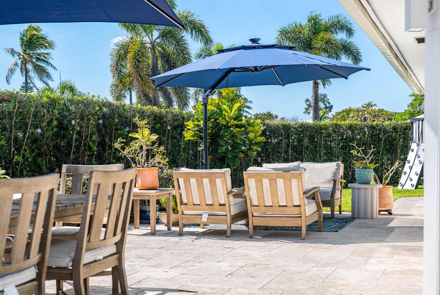 Absolutely MINT! This 4-bed/2-bath single family home in the heart of Atlantis is ready for its new and proud owner. Talk about style and upgrades with this warm modern, chic property offering the perfect blend of style and functionality. Sited on one of the best Lots in the community, this has the utmost privacy with a lush podocarpus hedge, tons of green space and French pattern travertine deck perfect for entertaining. You are immediately greeted through your double door entry with a vast open floor-plan and tons of natural light. The morning room features wall-to-wall hurricane impact sliders, perfect for dining and cozy living space. Beautifully remodeled kitchen with quartz countertops, tons of storage space and SS Appliance package overlooking the entire home. Custom details throughout with updated bathrooms, beautiful fixtures, decorative accent walls and thoughtful designs. The list doesn't stop there! This home has an oversized paved circular driveway + carport, updated laundry room with excess storage, closet build-outs and a whole home $3,000 water filtration system, you can drink from any tap! This stunner is truly .. A must see!