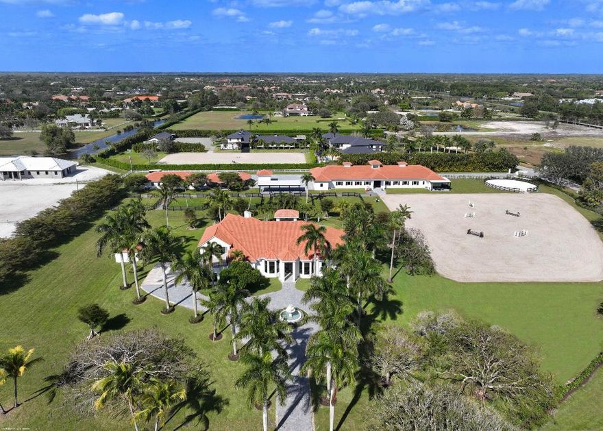 Experience the pinnacle of luxury equestrian living at this exceptional 7.17-acre estate, ideally located in Palm Beach Point and just a short hack to Wellington International. Designed for those who value sophistication, privacy, and world-class equestrian amenities, this property offers the rare combination of a grand residence and a fully equipped training facilityset within one of the most prestigious equestrian communities in the world.

Main Residence
Elegant and timeless, the main home spans over 5,000 square feet of meticulously designed living space. Highlights include a gourmet chef's kitchen, expansive great room, formal dining area, executive office space and serene owner's suite with spa-style bath and panoramic views of the property. High ceilings, custom finishes, and natural light throughout create an atmosphere of comfort and understated luxury.

Equestrian Facilities
Equipped for professional training and competition, the state-of-the-art barn features 12 stalls, tack and feed rooms, several storage areas, a lounge, round pen, covered walker and direct access to large grass paddocks. The "ebb and flow" oversized arena offers premium footing for year-round riding, while the property's layout provides effortless movement between barn, arena, and turnout areas. In addition, the property features an oversized double garage/storage with two independent grooms' quarters.

Barn is leased for 2025/26 season.