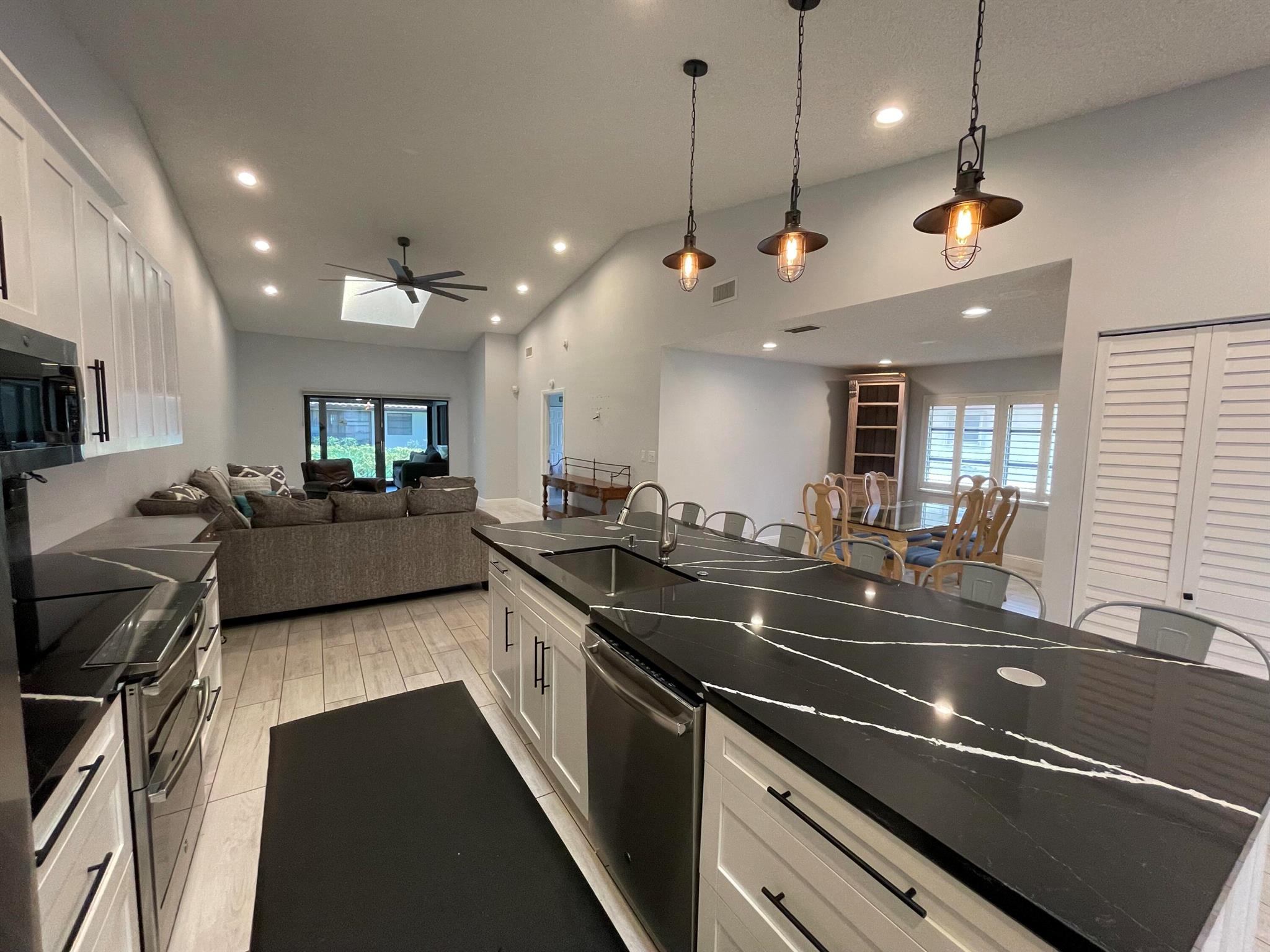 Welcome to this beautifully designed villa, featuring a chef's and entertainer's kitchen with modern finishes and ample space to host and gather. The open-concept layout with vaulted ceilings creates an airy, inviting atmosphere you'll love coming home to.The spacious primary suite offers comfort and convenience with dual sinks, a walk-in shower with a rainforest showerhead, and a built-in seat. With 2 bedrooms plus a den, 2 bathrooms, and a 1-car garage with 2 additional driveway spaces, this home is as functional as it is stylish.Enjoy year-round comfort in the enclosed, air-conditioned patio, the perfect spot to relax or entertain, or head outside to the outdoor patio. Just a short walk from the pool and clubhouse, this active 55+ community is filled with amenities, including