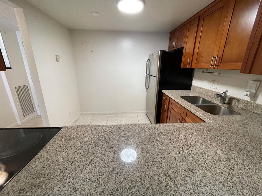 First-floor condo with updates and stainless steel appliances. Enjoy a beautiful view and outstanding location! Park in the back and enter your unit directly, where you can conveniently place your groceries on the balcony, giving you a house-like living experience. Water, trash, and basic cable are included. The recently remodeled clubhouse, fitness center, swimming pool area, and recreational facilities offer a fantastic lifestyle. Ongoing upgrades are being made throughout the common areas under new management. Stay active with a future walking/biking trail by the waterfront. Nearby Palm Beach Outlets, Palm Beach International Airport, and just 5 minutes from I-95. Comes with two assigned parking spaces.