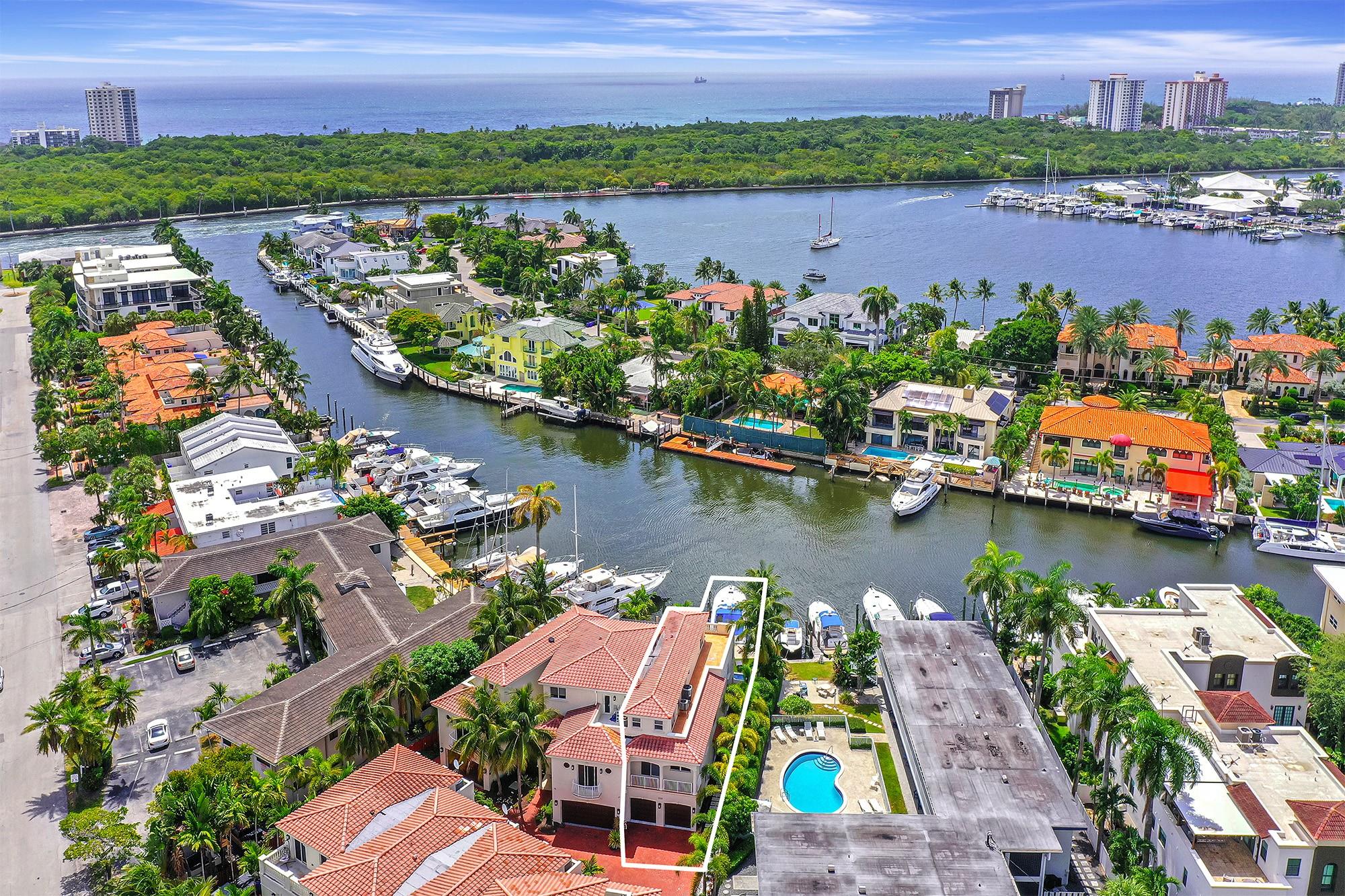 Boater’s DREAM! 4 Bed + Den & 3.5 Bath townhome with no fixed bridges and ocean access! Ideally located on the SE corner of one of Coral Ridge’s widest deepwater canals just off the Intracoastal. Enjoy a newer raised concrete dock that fits up to a 54'± yacht along with a private heated pool. This light-filled residence offers stunning water views, vibrant sunrises and sunsets and an elevator serving all 3 levels. Private side entry leads to open-concept living, kitchen and dining area. Primary suite and guest room on 2nd floor; 2 more beds plus a large terrace on the 3rd floor. Multiple balconies, plenty of storage and a 2-car garage with extra parking. Moments to the beach, Bayview A+ school zone, Cardinal Gibbons, Pine Crest, Galleria Mall, parks and more.