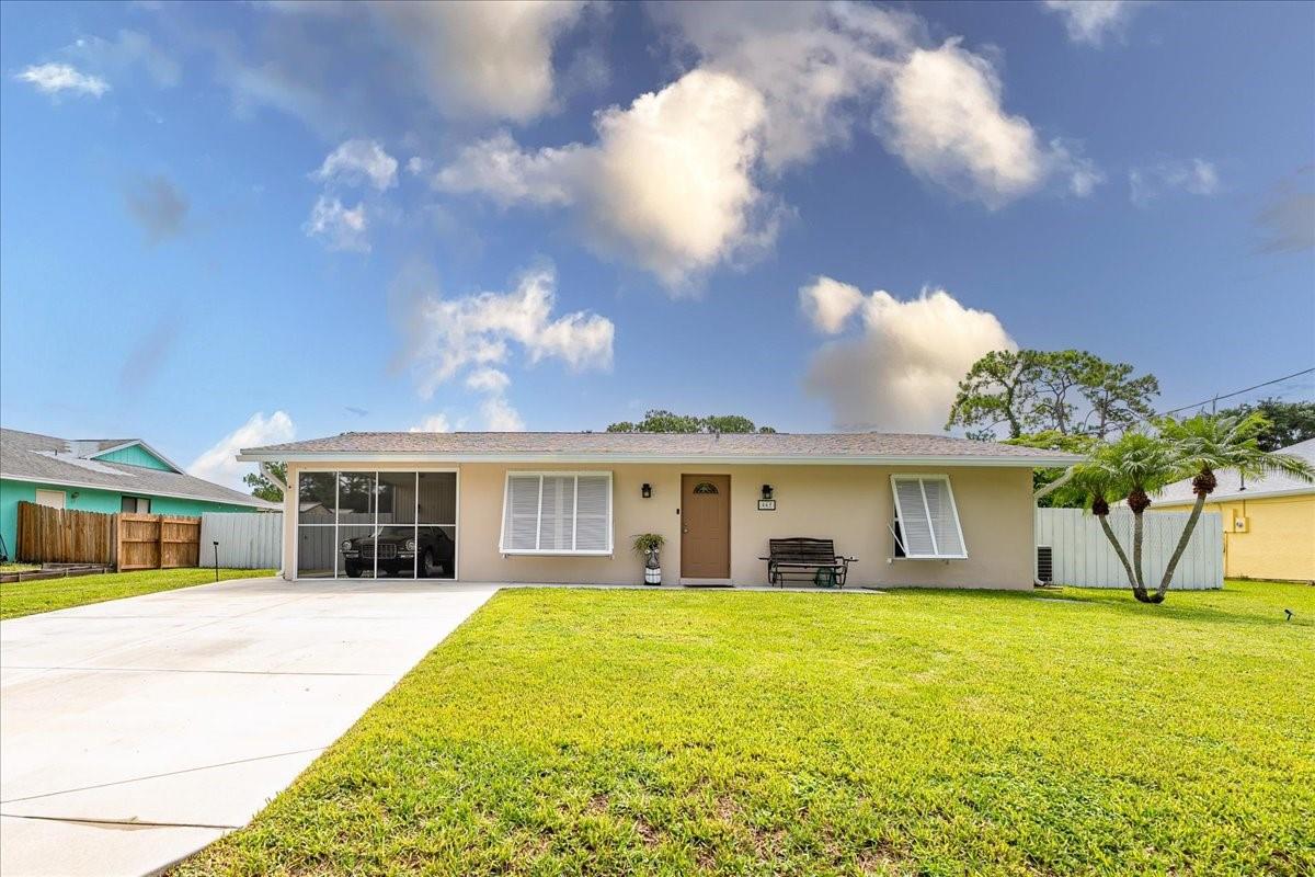 Welcome to 465 NE Midvale—your charming ocean access, waterfront retreat in Port St. Lucie! This 2BR/2BA home features a two-year-old roof, a beautifully remodeled kitchen with modern finishes, and a spacious, screened patio overlooking the water. Enjoy your private dock, perfect for relaxing, fishing, launching a kayak or docking your boat in your own back yard! A city-owned lot behind the home provides added privacy and will never be developed. Additional updates include a 2023 water heater and a 2017 A/C unit, a covered carport, and no HOA. Ample lot and side entry gate offers plenty of room to store your toys! This move-in-ready gem offers both comfort and convenience in a prime location near beaches, shopping, and dining!