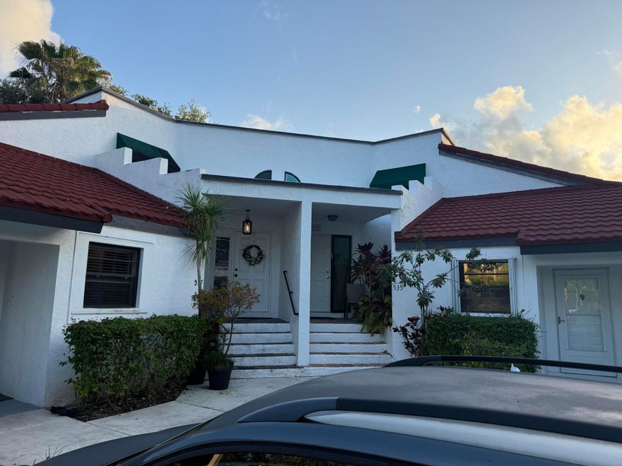 Beautifully updated end-unit villa in Deer Pointe, just minutes from the Boca Raton line. This move-in-ready home features an open-concept layout with updated flooring and a modern kitchen with 42" wood cabinets, quartz countertops, stainless steel appliances, pantry, and recessed lighting. The primary suite includes a custom walk-in closet and updated ensuite bath, with both bathrooms refreshed. Enjoy a screened patio with garden and partial lake views. Additional features include new roof (2024), A/C and water heater (2020), hurricane shutters, exterior storage, updated lighting, doors, and finishes throughout. Convenient parking directly in front. Low HOA with pool, hot tub, and pet-friendly community.
