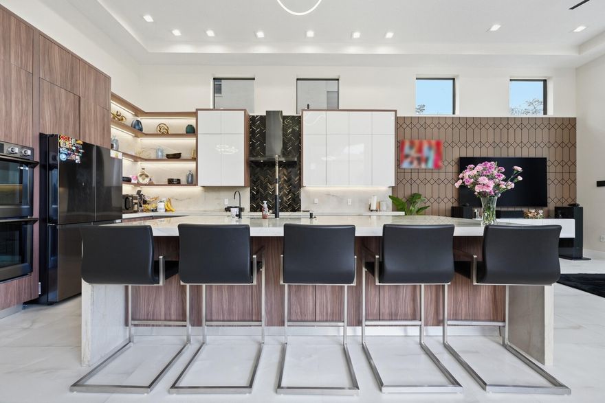 Discover this modern masterpiece, completely rebuilt in 2022 with top-quality materials.
Designed as a luxurious, safe, and energy-efficient retreat for today's professionals, the 4,034-square-foot estate boasts an open-concept layout that connects indoor living spaces seamlessly with the outdoors through extensive structural upgrades.
Enjoy peace of mind with impressive features like a powerful 30K solar array for nearly zero utility costs, dual high-efficiency HVAC units, and full-impact glass windows and doors. Inside, 13-foot ceilings and large sliding doors lead you to a private tropical oasis.
The intentional design includes expansive porcelain flooring, a chef's kitchen with a double-sided island, and elegant black stainless-steel appliances. Discover this modern masterpiece, completely rebuilt in 2022 with top-quality materials.
Designed as a luxurious, safe, and energy-efficient retreat for today's professionals, the 4,034-square-foot estate boasts an open-concept layout that connects indoor living spaces seamlessly with the outdoors through extensive structural upgrades.


Enjoy peace of mind with impressive features like a powerful 30K solar array for nearly zero utility costs, dual high-efficiency HVAC units, and full-impact glass windows and doors. Inside, 13-foot ceilings and large sliding doors lead you to a private tropical oasis.
The intentional design includes expansive porcelain flooring, a chef's kitchen with a double-sided island, and elegant black stainless-steel appliances.


The kitchen is truly the heart of this home, offering a professional induction range, custom cabinetry, and a stunning waterfall stone island. The primary suite continues this luxury vibe, serving as a wellness retreat with floor-to-ceiling porcelain finishes and a spacious, seamless shower.


Behind the scenes, advanced systems power the home. The robust 30KW solar setup eliminates monthly energy bills and supports charging for two electric vehicles. Climate comfort comes from an eight-zone industrial-grade system, and closed-cell spray foam insulation offers complete sound and temperature control.


Water quality is prioritized with a full-home filtration system that treats every tap and shower, plus specialized purification for the refrigerator. With features like touchless sensor faucets and a smart-automated pool, this property delivers exceptional autonomy all just minutes from Wellington's renowned equestrian facilities.!