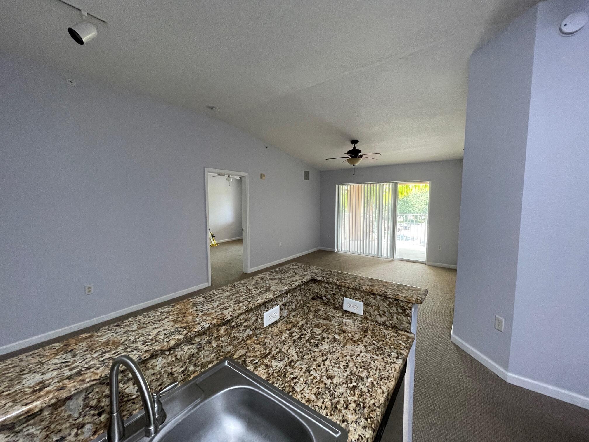 Palm frond shaded, Very Nice Third Floor Condo for Annual Lease. Granite and Stainless! Full 2 Bedrooms plus 2 Baths. The Master Bath has a Roman Tub / Shower, and also there is an additional sit-down vanity outside of the bathroom. The kitchen offers oak cabinets and there is a full size Washer and Dryer in the Utility Room. Ceramic tile in kitchen and baths, and laundry room. Master has a large walk-in closet. There is a nice balcony, plus a storage room outside the front door. Water & garbage are included. Check out the pool! Located across the street from Publix, LA Fitness, Home Goods, Pollo Tropical , Tijuana Flats and everything else in St Lucie West. This is a third floor unit with higher ceilings! (Continued)