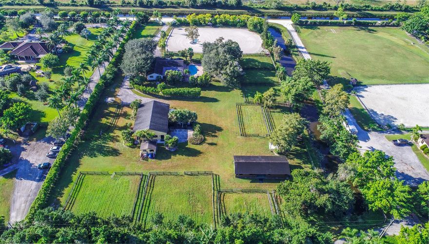 Very private 5 acre property. 6 bedroom, 3 bath furnished house with private pool.Equestrian amenities include  220' x 180'  ring.Two barns with 8 stalls each, and ample room for temporary stalls.  4 wash stalls attached to first barn, tack room, feed shed, 10 large paddocks. Maintenance machinery on site.