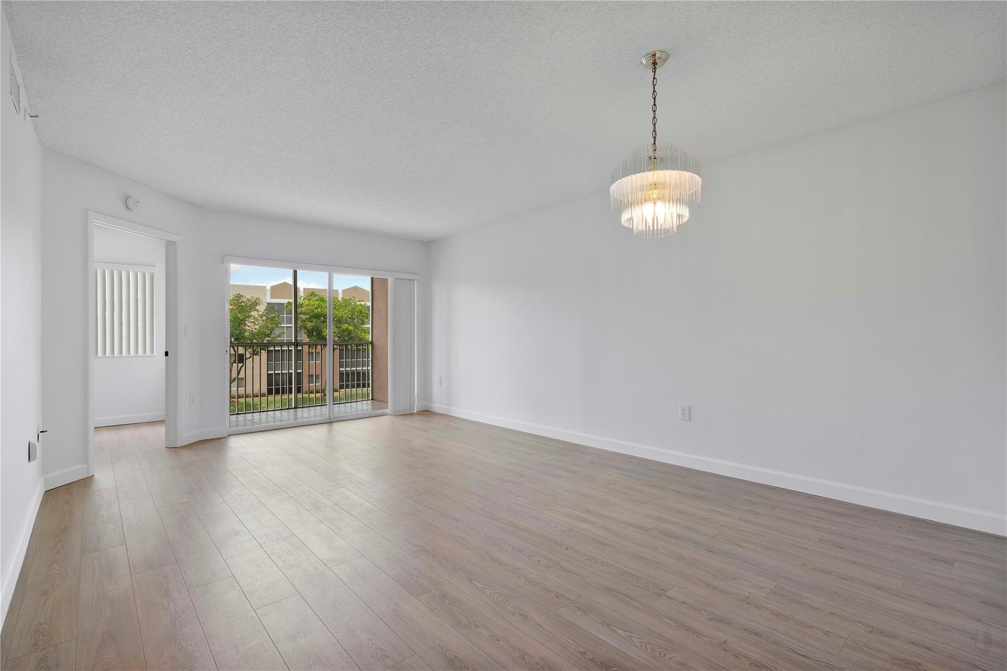 Welcome to this stunning 2 bed, 1.5-bath condo in the highly desirable Weldon 55+ premier community at Kings Point. Updated unit features brand-new vinyl flooring, and fresh interior paint throughout. Enjoy breathtaking lake views from your screened balcony and bright living area. The spacious layout includes a walk-in closet in the main bedroom, washer and dryer in unit, and the convenience of being just steps from the elevator, no stairs needed! Enjoy resort-style amenities including 24/7 manned gate security, multiple clubhouses, pools, a fitness center, theater, social activities, and a courtesy shuttle to nearby shopping, dining, and entertainment. Basic cable included and the location is just minutes from Sawgrass Mills Mall, parks, and major highways.