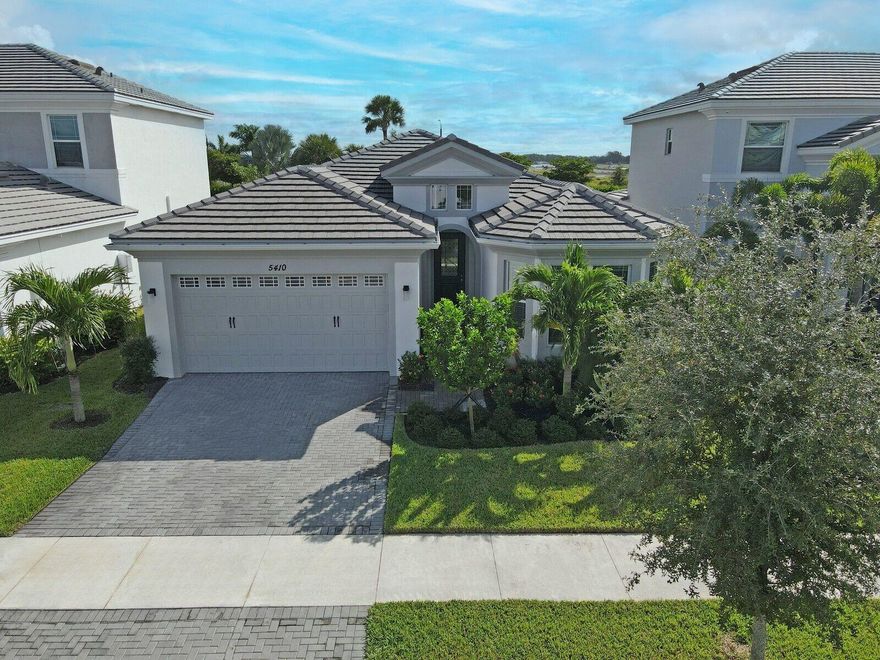 Welcome to this stunning Schefflera model in The Orchards of Westlake, offering 2,305 sqft of beautifully designed living space with 3 bedrooms plus a den, 2.5 bathrooms, and a 2-car garage. Every detail has been cared for with intention, creating a clean, comfortable space that feels like home the moment you step inside.Featuring full hurricane impact protection and extra added insulation for comfort and efficiency, this home also showcases ceramic tile flooring throughout. The bright kitchen offers white shaker cabinets, quartz countertops, stainless steel appliances, a gas range, and an extended island with a spacious corner pantry. The countertop is also extended for a convenient buffet-style setup--perfect for entertaining.