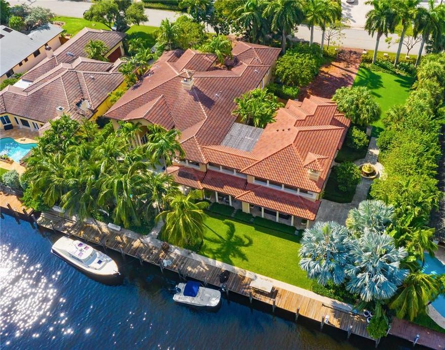Unique mega-estate sits on approx 2/3 of an acre in 24-hour patrolled Seven Isles. 160 ft of deepwater might fit 100 ft yacht. The primary house features a two-story great room with a fireplace & walls of glass overlooking the pool. Impact glass, elevator, full house generator. Library equipped with a full bath. Upstairs master suite with sitting area, gym, and balcony. Two separate guest’s quarters presently used as HIS and HERS office. HIS Office features a full bath and closet. Her office includes sitting room, sink, two burners stove, full bath, & closet. Outdoor loggia includes four sitting areas plus a dining area next to a fully equipped outdoor kitchen and gas fireplace. Temperature-controlled wine cellar with 600 bottle capacity. Pool & Jacuzzi with waterfall and fire pits.