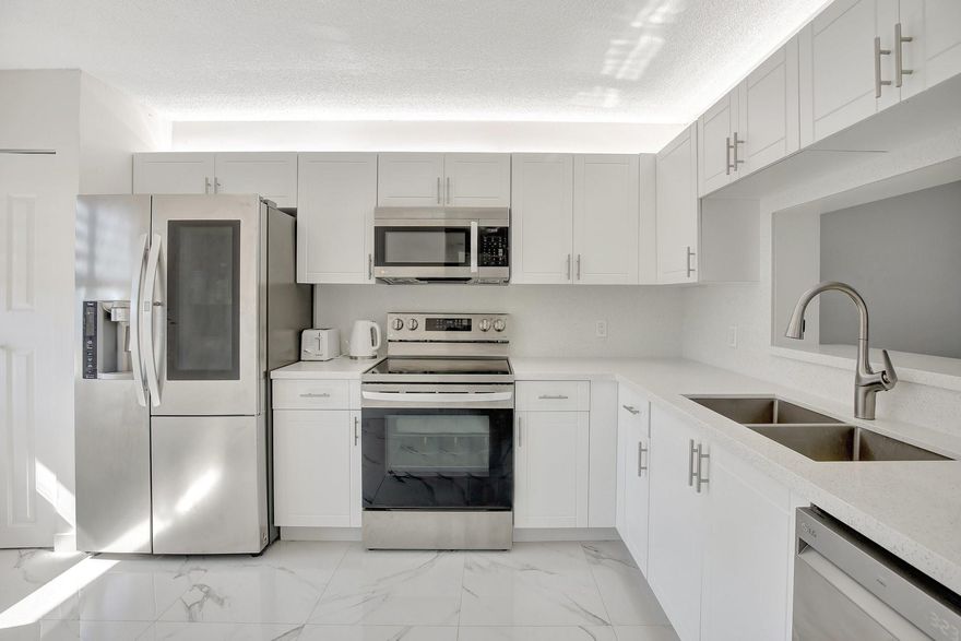 Stunning, fully remodeled condo with lake view—where no detail was spared and quality upgrades shine throughout. The owner invested generously to create a modern, move-in-ready retreat: Ceramic tile flooring, brand-new electrical/ plumbing systems, fresh & sophisticated ambiance. Designed Kitchen, Quartz countertops, custom cabinetry, stainless steel appliances. Beautifully renovated bathrooms with contemporary finishes,  zebra blinds throughout the unit add both elegance and control over natural lighting. 55+ community with resort-style amenities including pools, fitness centers, and an active clubhouse, this home offers the ideal blend of comfort, style, and convenience. Water, cable, and internet included in the maintenance fee. No rentals allowed for the first 2 years of ownership.