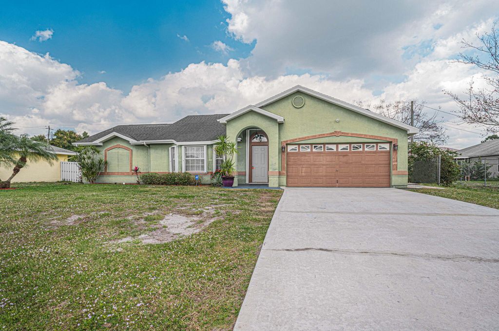 Photo of 407 SW Laconic Avenue, Port Saint Lucie, FL 34953 (MLS # R10959012)