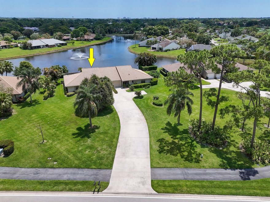 Tucked within the gates of Eastpointe Country Club, this well maintained home offers a comfortable layout, thoughtful updates, and an easy Palm Beach lifestyle. The living spaces are bright and inviting, featuring high ceilings with recessed lighting and updated flooring throughout the main living areas and bedrooms, creating a clean and cohesive feel.  The kitchen is thoughtfully positioned with a picture window overlooking the lake and a convenient pass through to the dining room, bringing in natural light while maintaining a defined layout. The home offers generously sized bedrooms, including a remodeled guest bathroom that adds a fresh, modern touch. Enjoy peaceful lake views from the living areas and outdoor space, creating a relaxing backdrop to everyday living. A long driveway  provides added convenience and extra parking, along with a one car garage. Located in a gated community, Eastpointe Country Club offers golf, a clubhouse, fitness center, tennis, pickleball, and a variety of recreational amenities, all within close proximity to shopping, dining, and area beaches.