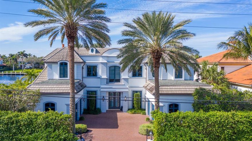 Overlooking the Intracoastal waterway in tropical splendor, this Regency-inspired deepwater estate was created by Bomar Builders and architect Carlos Martin.  Styled in the grand European tradition, the elegant masterpiece presides over lushly landscaped grounds with dramatic night lighting.  An impressive gated entry give way to a brick motor court serving the 4-bay garage.  Alongside the Intracoastal, triple large loggias surround the resort-style infinity-edge pool, amidst manicured formal gardens.  A fireplace, summer kitchen and cabana bath appoint this expansive outdoor entertainment area.  Complete with a boatlift, extensive yacht dockage serves the private 100'± waterfront. DISCLAIMER: Information published or otherwise provided by the listing company and its representatives including but not limited to prices, measurements, square footages, lot sizes, calculations and statistics are deemed reliable but are not guaranteed and are subject to errors, omissions or changes without notice. All such information should be independently verified by any prospective purchaser or seller. Parties should perform their own due diligence to verify such information prior to a sale or listing. Listing company expressly disclaims any warranty or representation regarding such information. Prices published are either list price, sold price, and/or last asking price. The listing company participates in the Multiple Listing Service and IDX. The properties published as listed and sold are not necessarily exclusive to listing company and may be listed or have sold with other members of the Multiple Listing Service. Transactions where listing company represented both buyers and sellers are calculated as two sales. The listing company's marketplace is all of the following: Vero Beach, Town of Orchid, Indian River Shores, Town of Palm Beach, West Palm Beach, Manalapan Beach, Point Manalapan, Hypoluxo Island, Ocean Ridge, Gulf Stream, Delray Beach, Highland Beach, Boca Raton, East Deerfield Beach, Hillsboro Beach, Hillsboro Shores, East Pompano Beach, Lighthouse Point, Sea Ranch Lakes and Fort Lauderdale. Cooperating brokers are advised that in the event of a Buyer default, no commission will be paid to a cooperating Broker on the Deposits retained by the Seller. No commissions are paid to any cooperating broker until title passes or upon actual commencement of a lease. Some affiliations may not be applicable to certain geographic areas. If your property is currently listed with another broker, please disregard any solicitation for services. Copyright 2021 by the listing company. All Rights Reserved.