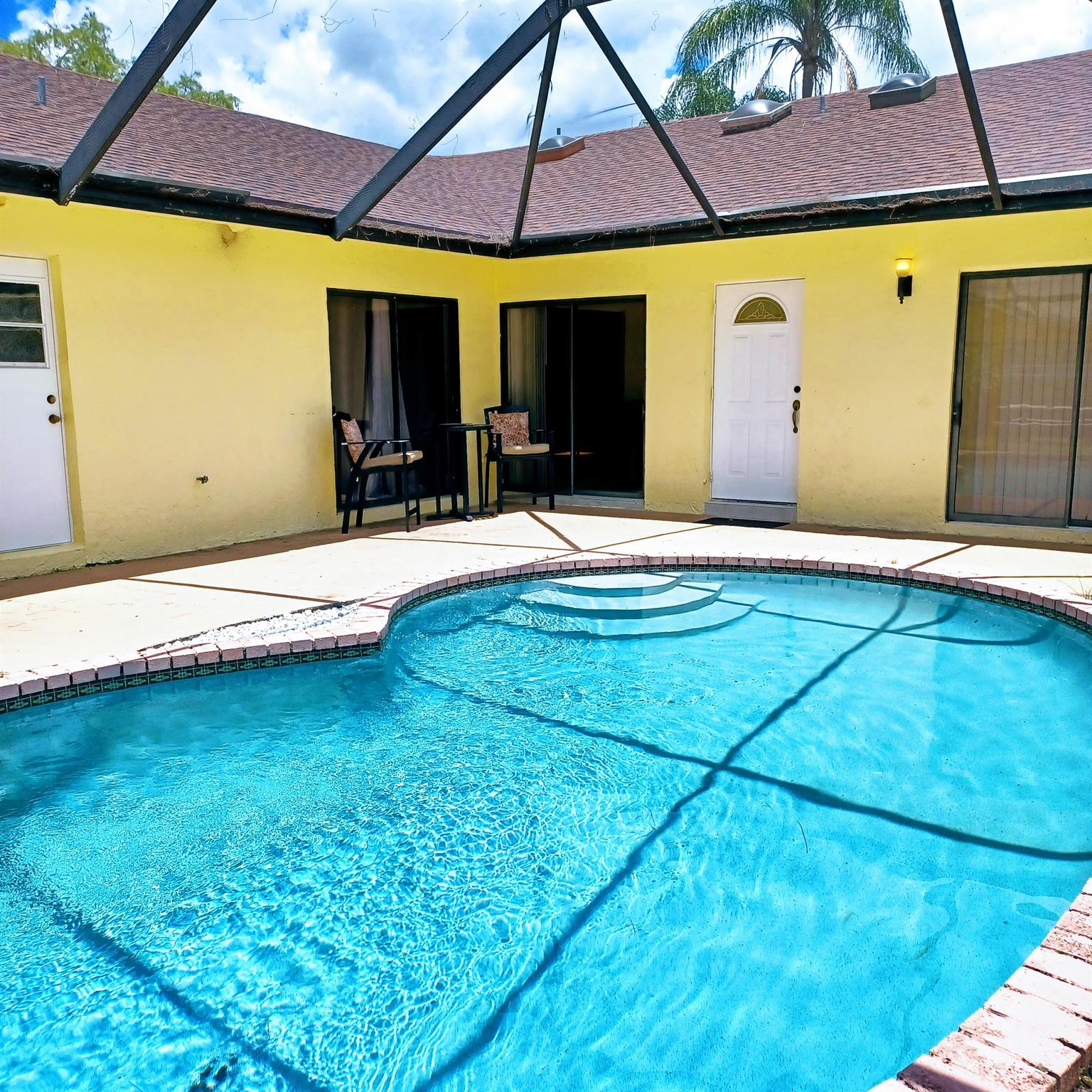 Conveniently located villa with own private swimming pool. Walking distance to 2 major plazas with all kinds of stores including the new Publix. 3 spacious bedrooms with beautiful wood like tile floors. Renovated kitchen with granite countertops and plenty of space to prepare meals. Each bedroom and living room with sliding doors to the swimming pool. Vaulted ceiling and abundant natural light. NO HOA. A fenced backyard with fruit trees