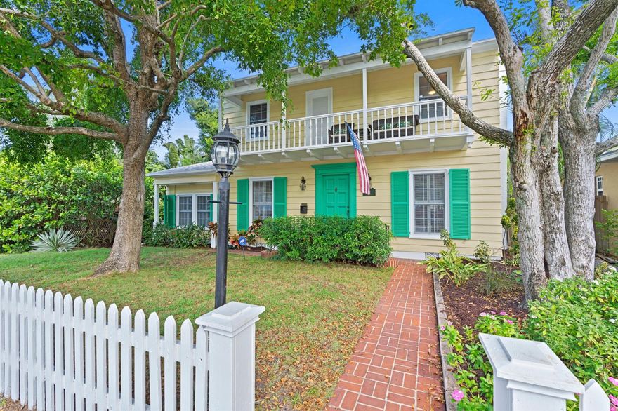 Key West style Florida Colonial home on a 12,850 sq. ft. lot. First time on the market, beautiful original Oak hardwood flooring throughout, original fireplace, freshly painted inside and out. Spacious pool deck with tropical mature landscape including mango and coconut trees. Charming second floor balcony. The out building can be improved to make a guest cottage. There is extra parking from the rear alley access, and room for a garage.  Newer roof, natural gas appliances, updated baths, updated electric,  Move-in-condition. The main house could be converted to a duplex, and additional units could be built on the extra lot with existing muti-family zoning. This is a great opportunity, 1 block to downtown, and less than 1 mile to the beach.