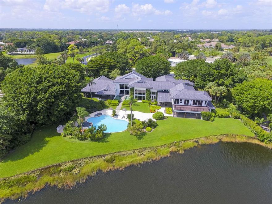 Magnificent Lakefront Estate located on 1.35 beautifully landscaped acres inside the double gated Enclave subdivision of Breakers West, affords added security, privacy and completely unobstructed views of the golf course, lake, and forest beyond. The Asian/Zen inspired construction includes 6 bedrooms, grand living room with 21' ceiling, brand new German gourmet kitchen with Miele appliances, formal cove ceiling dining room, family room with wet bar and wine refrigerators, fully equipped gym, large game room and two expansive terraces for outdoor living, dining and unsurpassed entertaining.