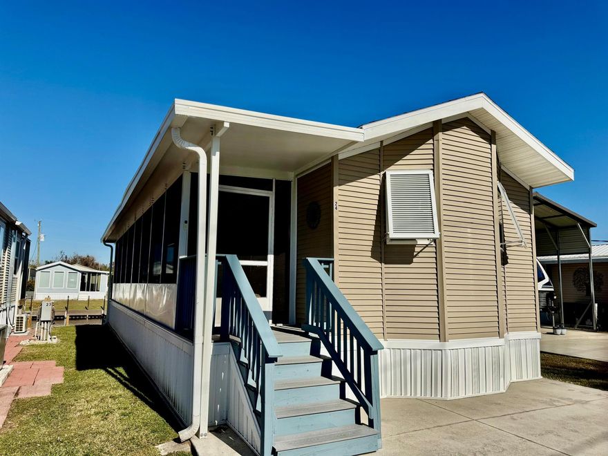 TURTLE COVE~ A RARE FIND! For the ONE who ONLY WANTS THE BEST!  Lake ''O'' Access. Exceptional 2018 PALM HARBOR Park Model. 20x25 Garage/workshop w/ 20x24 Double carport. 1 Bd/1 Ba. 942 TLA with screened porches. Beautiful in every detail, furniture included.  Open concept, LVP flooring, stacking W/D. Full shower. Lots of storage. Queen hideabed in the living room with a chaise lounge. Table for four. Bimini Hurricane shutters. Open the double door on the water side and enjoy the beautiful breeze throughout the home. Full length screened porch and lovely back porch. Open patio at seawall. All concrete board decking and steps. Concrete Seawall. Built at 150 Mph Wind Load capacity. Top Quality!  MOVE IN THIS SEASON!Dimensions are approximate, must measure for exact