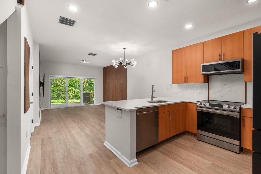 Move-in ready townhouse at the Oaks of Oakland Forest in Oakland Park! This two-bedroom, two-and-a-half-bath home features luxury vinyl flooring and an updated kitchen with quartz countertops and newer appliances. Major upgrades include impact windows and sliders, updated electrical, and a newer A/C with air purifier and ductwork. Upstairs offers updated closets and automatic blinds in bedrooms and living room. Additional highlights: Samsung washer/dryer, updated water heater, whole-house water softener, and a refreshed garage with new door and flooring. Neat Addition: built-in dog house under the stairs. Stylish, functional, and turnkey!