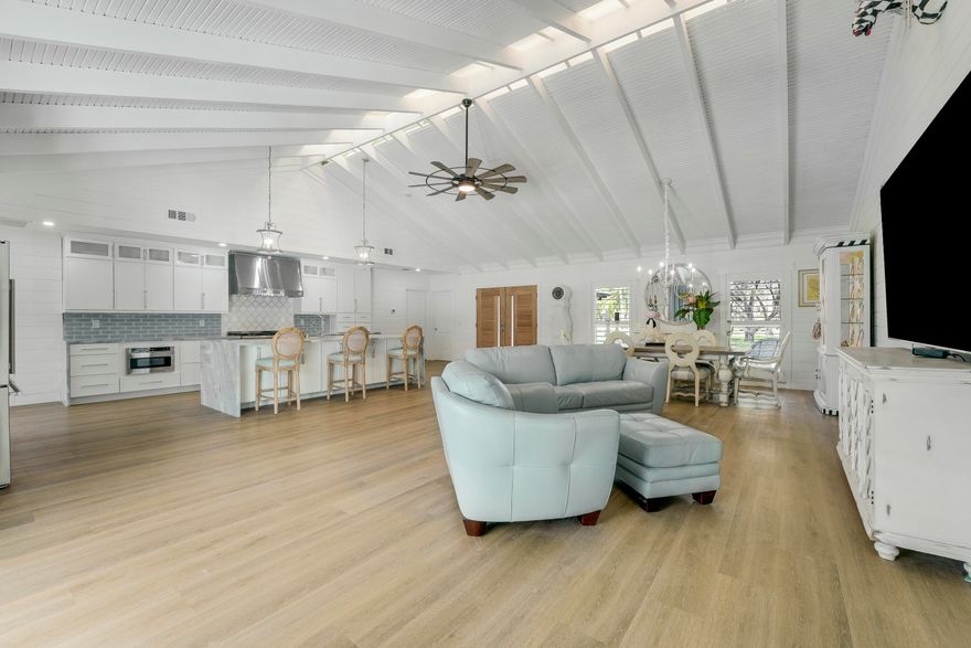 Imagine everyday seeing wide open views of water on a golf course. Relax in your completely redone mosaic swimming pool & marble deck. The house has a completely open floor plan with 13-foot ceiling in greatroom & kitchen. The dream chef's kitchen which includes a 48'' gas stove with griddle & 48'' designer hood and blue marble countertops. 2 refrigerators, 2 freezers that are surrounded by pantries. All new impact windows and doors, new air conditioners, new bathrooms, new flooring, the house was completely remodeled down to the studs! All bedrooms have their own ensuite with high end tile. The main bedroom has an office and 9' door sliders leading to the pool. The primary bathroom is a personal spa with marble tile, free standing tub, and an 8x8 rain shower with seating for 4. Located the exclusive gated community of Evergreen on over an acre lot. This home has been masterfully redesigned for functional and luxury living.