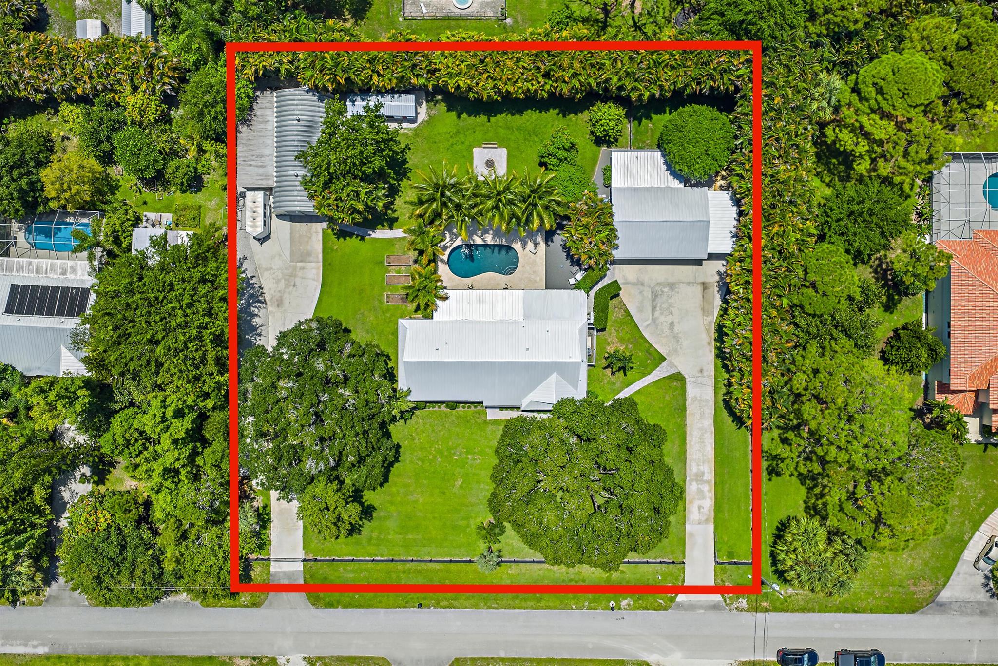 Experience modern country living with city convenience in Palm Beach Gardens. This fully remodeled 3-bedroom + office, 2-bath home sits on 1.15 acres with no HOA and has been upgraded top to bottom for peace of mind. Major updates include a 2023 standing seam metal roof, 2022 Lennox A/C with new ductwork, tankless propane water heater, impact windows with shutters, and a new septic/drainfield (2018).Inside, the open-concept layout centers around a designer kitchen with quartz countertops, custom cabinetry, and Thermador appliances with gas cooking, anchored by a modern vapor fireplace. Bathrooms, flooring, and finishes were fully updated in 2022.Step outside to a saltwater pool with travertine decking, a detached 3-car garage with bonus room, and a 25'x50' workshop with 50-amp ser