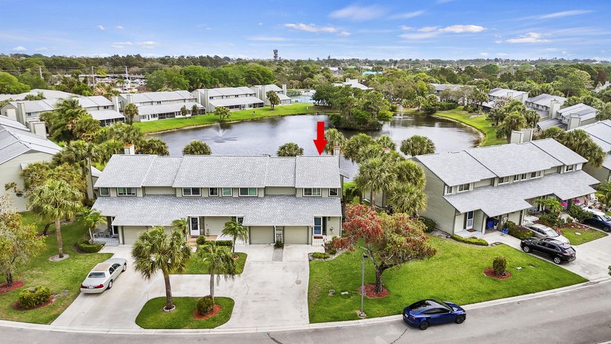 This stunning, fully upgraded END-UNIT townhouse with tranquil WATER VIEWS is in the heart of Jensen Beach. Luxury vinyl plank flooring flows seamlessly throughout, complemented by plantation shutters and elevated finishes in every room. The inviting living area features a cozy wood-burning fireplace. The kitchen is a true standout, showcasing quartz countertops, stainless steel appliances, and a convenient under-sink water filtration system. Retreat to the show-stopping primary bathroom, completely renovated in 2025 with high-end, modern design. Major upgrades already completed: IMPACT WINDOWS (2021) and sliders (2025), A/C (2020), water heater (2021), electrical panel (2021), and garage door (2021). Just a short stroll to charming downtown Jensen Beach and only minutes from the beach.