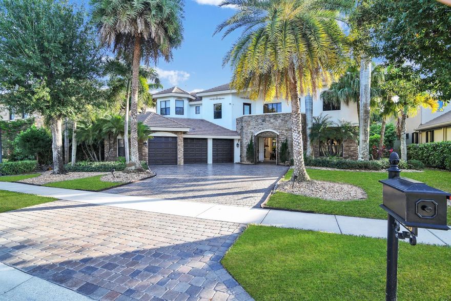 Set on a serene lakefront lot within Wellington's coveted Versailles community, this estate offers a lifestyle of comfort and sophistication. The backyard is the showpiece of the home, highlighted by a sparkling pool, relaxing spa, private gym area, and a hammock nook perfectly positioned to enjoy the water views. Indoors, the floor plan is designed for both work and entertaining, featuring a dedicated Library/office, a media/meeting room, a generous lounge, and a stylish bar that connects to the gourmet kitchen. Upstairs, the primary suite provides a peaceful escape with its own terrace overlooking the palms and lake. With 6 additional bedrooms, one office, warm wood elements, and custom-crafted storage throughout, the home provides abundant space and refined detail.