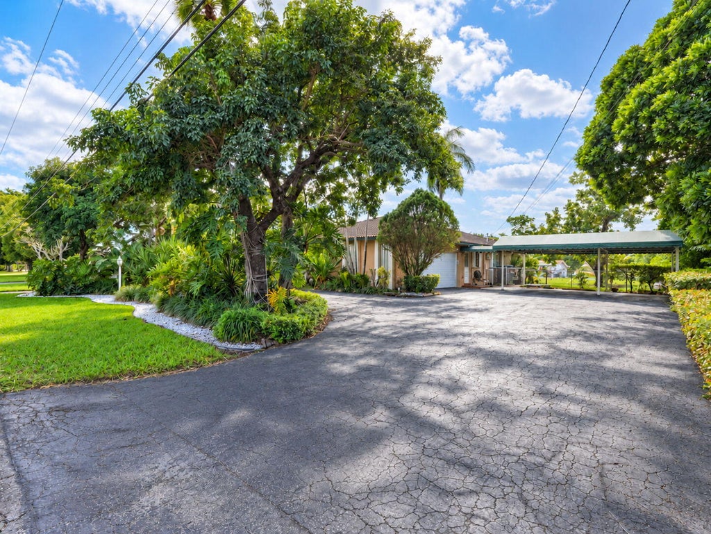 Photo of 937 W Tropical Way, Plantation, FL 33317 (MLS # B26092938)