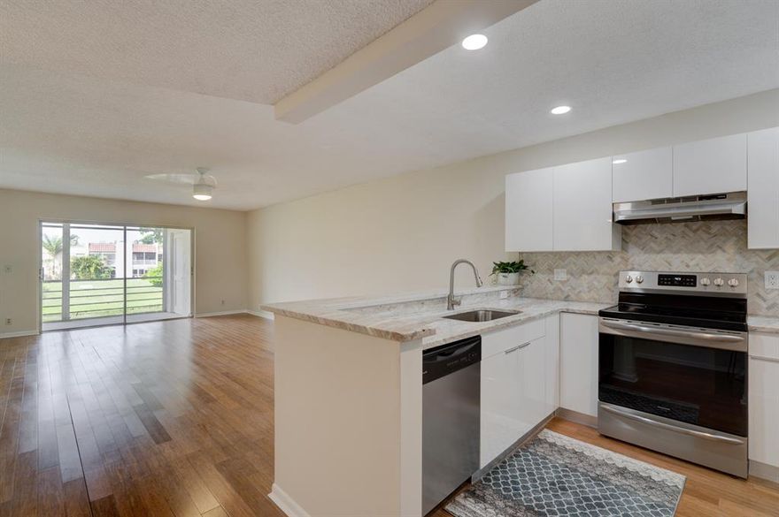 Stunning, completely renovated lakefront 2/2 condo in Lago Del Rey! Brand new open kitchen features white cabinetry, granite countertops and stainless appliances with the refrigerator, dishwasher and range relocated for better flow. A separate laundry room allows for no laundry in the kitchen! 
Both bathrooms have been completely renovated and feature exquisite tile floors and walls with craftsman detail and design. Both bedrooms offer fantastic closet space. This eco-friendly home features renewable bamboo hardwood flooring, high efficiency appliances and hurricane glass windows, as well as designer ceiling fans and new paint throughout! Inside corner unit. Amazing direct lake views from the screened porch! Being sold unfurnished as of 07/08/22. Minutes from desired Atlantic Avenue and one of the top area hospitals.