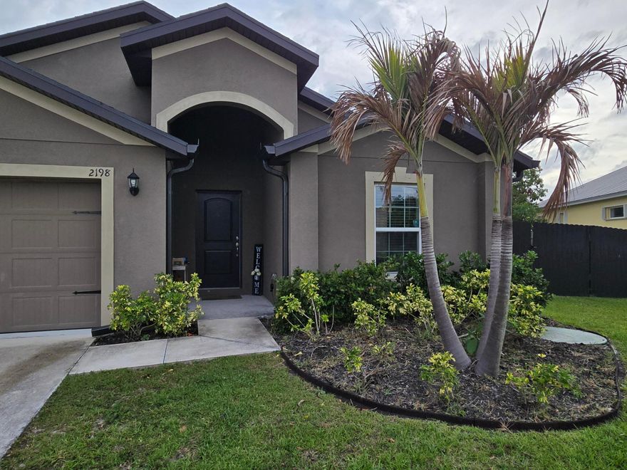Situated on an oversized corner lot in Port St. Lucie, this property offers exceptional outdoor space, privacy, and functionality. The fully fenced yard features a new aluminum fence installed in 2023. A 50-foot driveway extension and dedicated pad with gated access, completed in 2024, provide ideal space for RV or boat storage. The home also features an 800 sq ft covered patio built in 2025, including 500 sq ft screened, creating a perfect setup for year-round outdoor living and entertaining. A fully paid $30,000 solar system installed in 2023 with a 25-year warranty significantly reduces electric costs, and an FPL EV charger is installed in the garage. A new well and sprinkler system (2023) support efficient irrigation. Conveniently located near major roads, shopping, and dining.