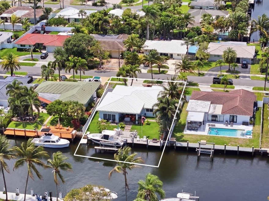 Beautifully reimagined waterfront home in the heart of Pompano Beach! This 3-bedroom, 3-bath residence with a versatile flex room has been completely renovated from top to bottom, featuring a new roof, new A/C, updated flooring, and smooth ceilings throughout. Enjoy 70 feet on one of the widest canals in the area, complete with a private boat lift—perfect for embracing the South Florida lifestyle. Over $350,000 in upgrades have been thoughtfully invested. thought the entire property.  Actual square footage differs from tax records. Light, bright, and move-in ready—coastal living at its finest!    Sunsets here hit different!