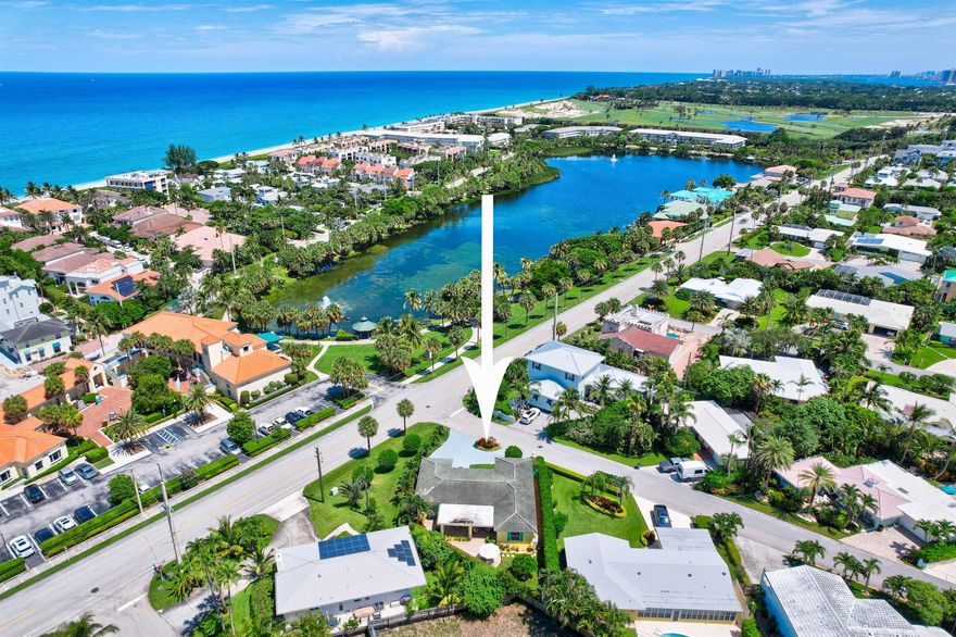 Perfect investment property meets coastal living in the picturesque town of Juno Beach. This charming 3 bedroom, 2 bath home is the perfect beach house. Whether you're looking for a serene beach retreat or a lucrative short term, turnkey rental, this home has it all. One of the few residences overlooking the serene Pelican Lake, this property boasts breathtaking views and tranquility. Just a block from the pristine sands, you'll enjoy the ultimate beach lifestyle. Step inside to discover beautiful hardwood floors throughout, highlighting the meticulous renovations. The spacious and bright living areas feature impact windows, ensuring safety and energy efficiency. Enjoy the convenience of custom closets and an updated electrical panel, adding modern touches to