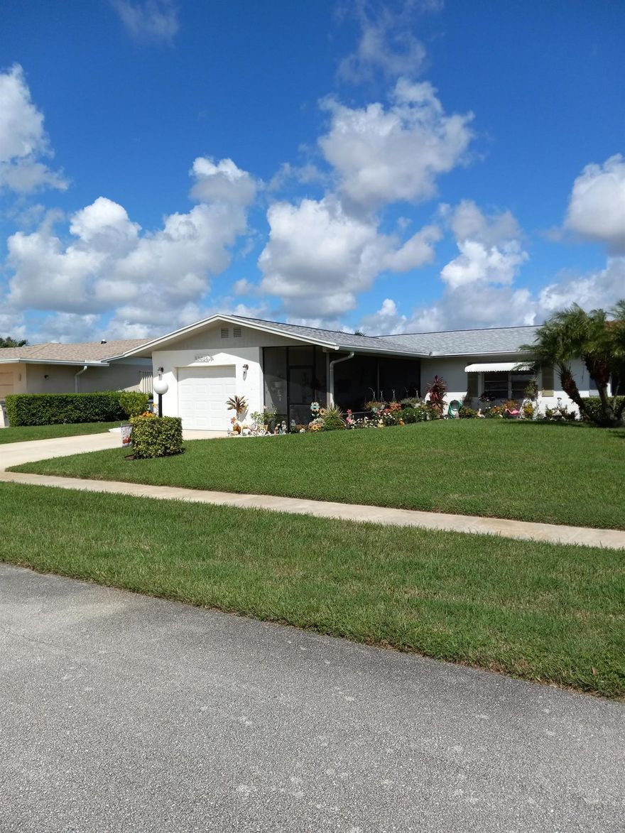 EXCELLENT OPPORTUNITY TO BUY LAKE VIEW END UNIT VILLA with brand new roof, large Florida room across the back plus screened in porch in the front, 2 Bedrooms 2 baths 1 car garage, huge closets, fridge, flat top stove, microwave above, dishwasher, washer, dryer, tile flooring throughout, central air.  A MUST SEE!