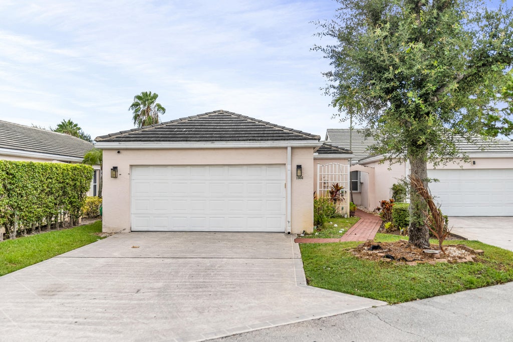 Photo of 1066 Island Manor Drive, Greenacres, FL 33413 (MLS # B26071036)